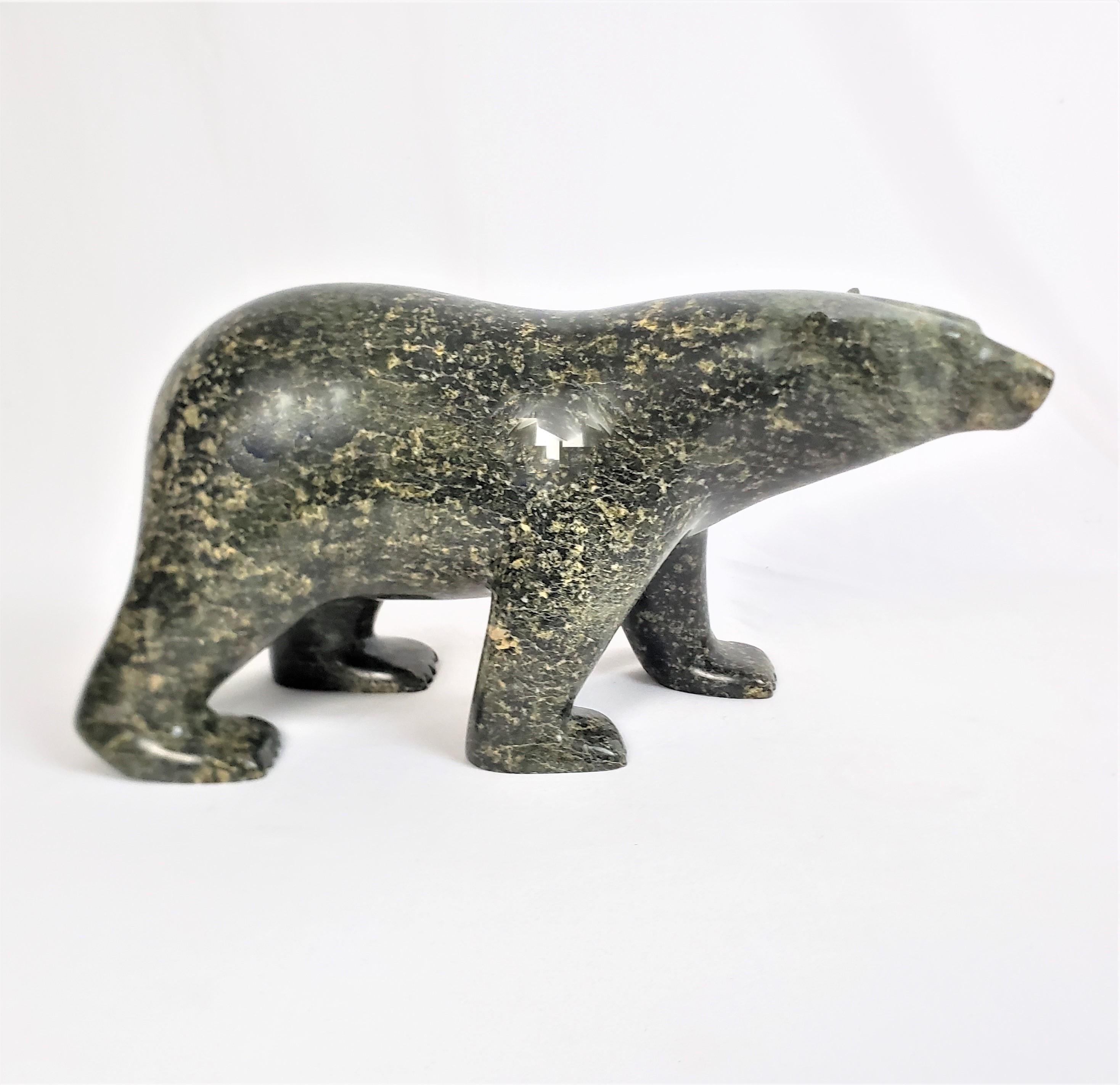 This large and well executed carved bear sculpture was done by the renowned Ashevak Adla of Canada in approximately 1999 in his signature Inuit style. The carving is composed of serpentine stone, which has been masterfully carved to depict a walking