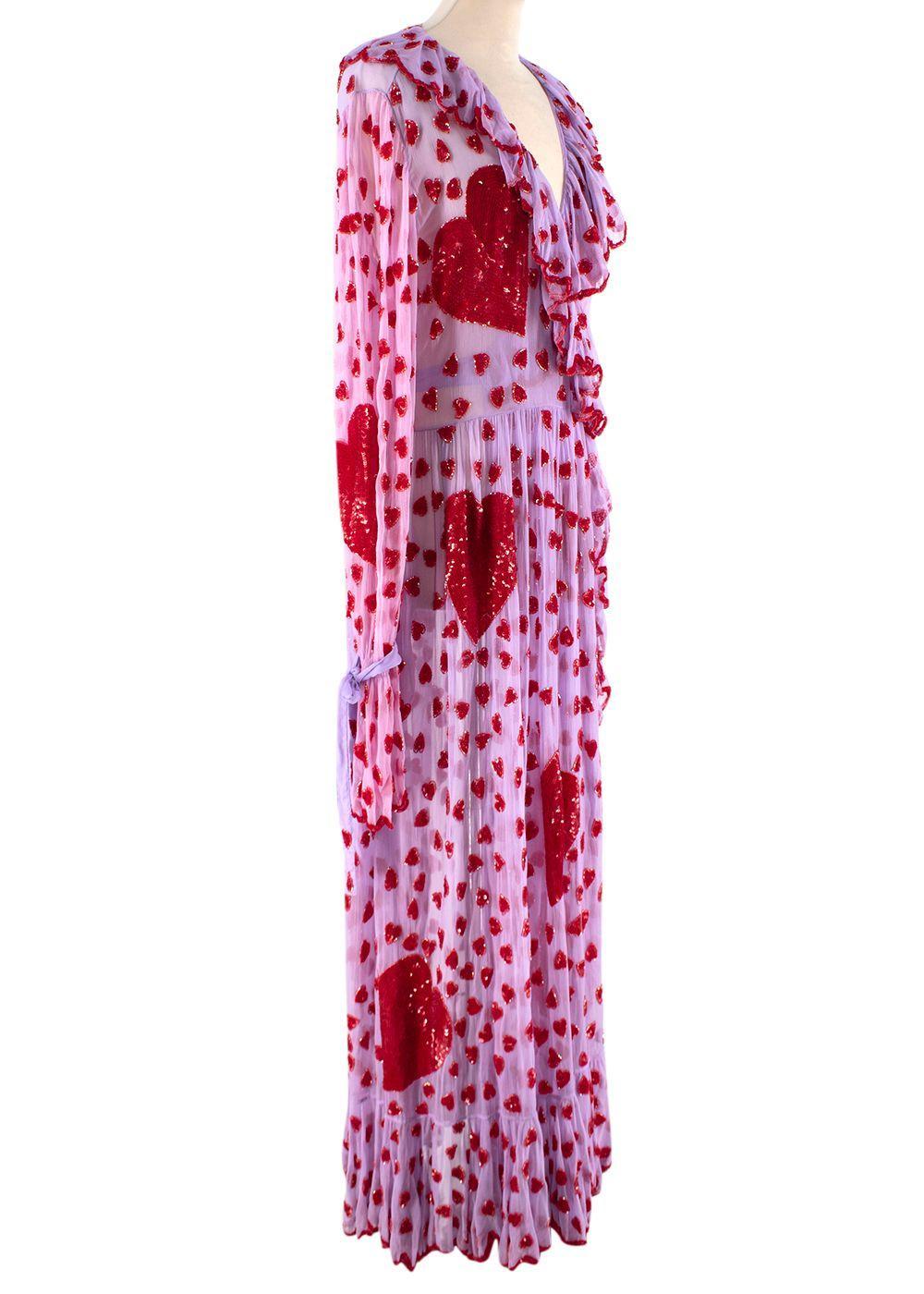 Lilac Chiffon Heart Embellished Wrap Dress

- Lilac sheer chiffon wrap dress
- Embellished in red heart-shaped sequins and beads
- Ruffled details to the oversized cuffs and collar
- Two side pockets

Materials:
100% Nylon

Made in India
Dry clean