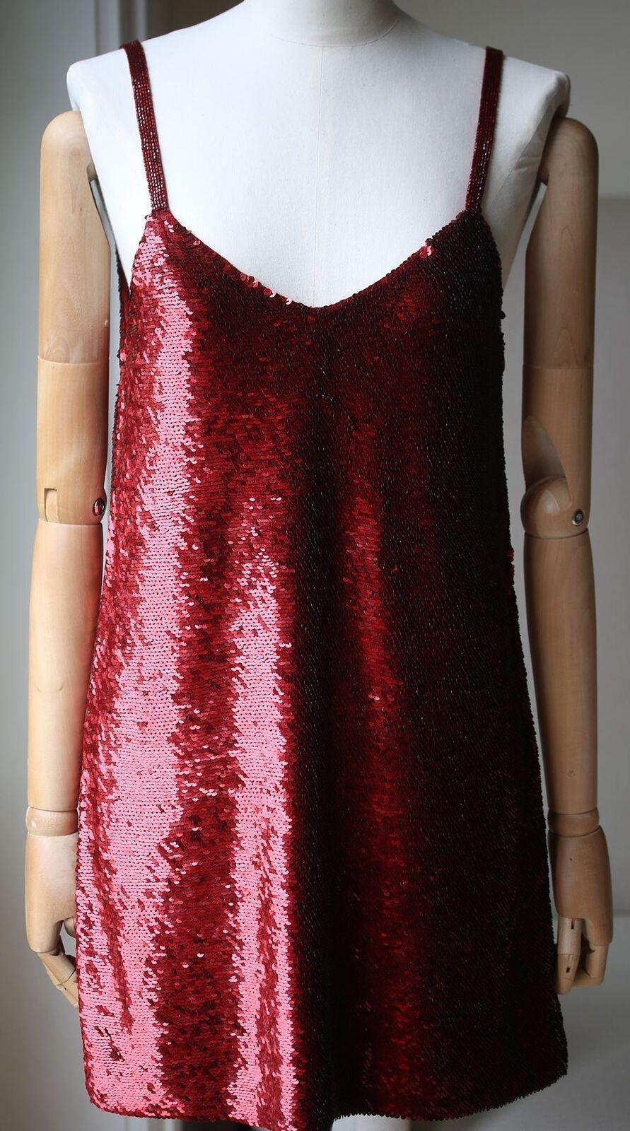 Embrace Ashish's tongue-in-cheek maximalist aesthetic with this ruby-red V-neck dress. 
It features hand-sewn sequin embellishments and is cut to a loose, fluid mini-length silhouette. 
Red sequins-embellished silk-georgette. 
Slip-on. 
100% Silk.