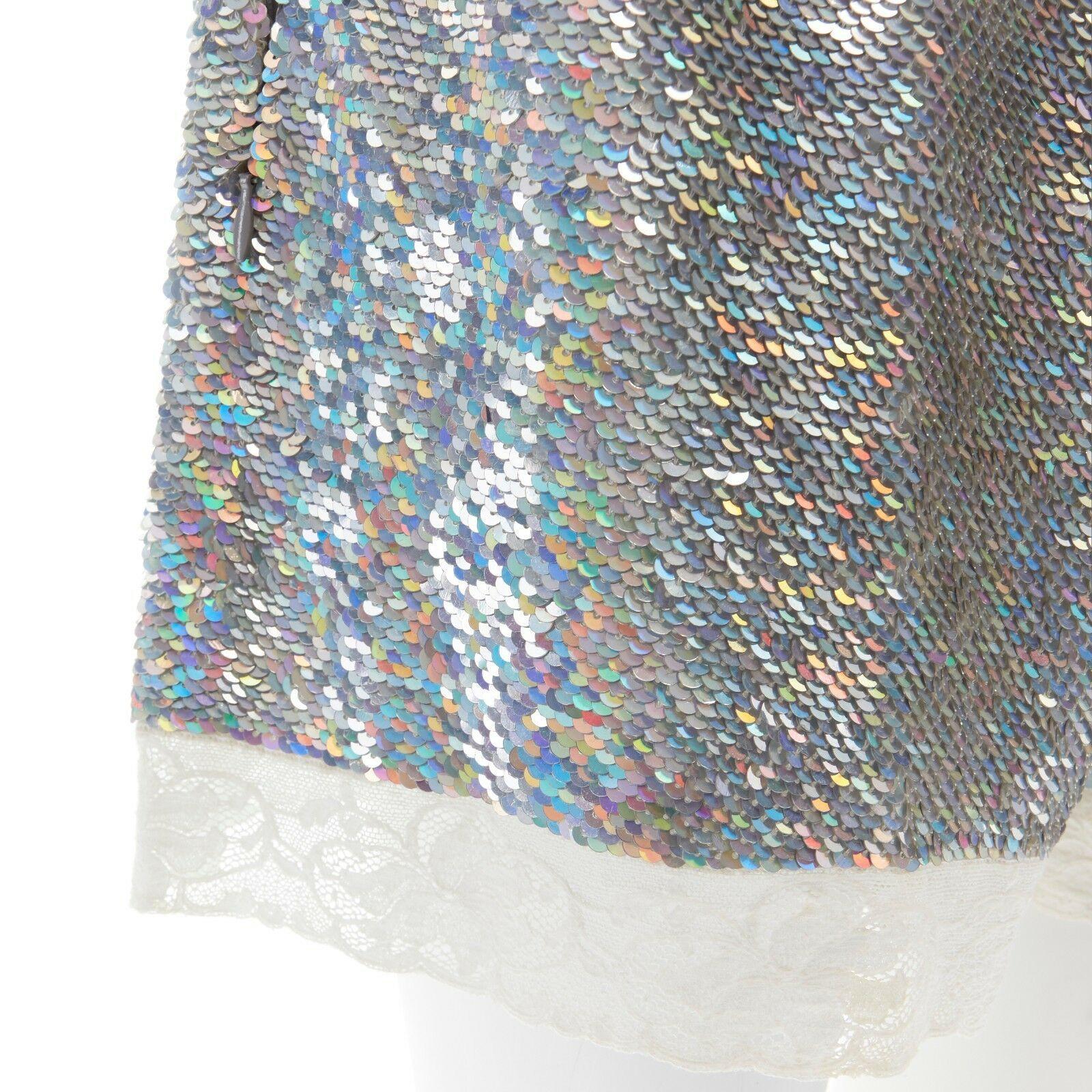 ASHISH silver iridescent sequins white lace hem drawstring cotton shorts XS

ASHISH
Iridescent silver sequins embellishment. White floral lace trimmed hem. Dual zip side pocket. Elasticated drawstring waistband. Cotton shorts. Made in