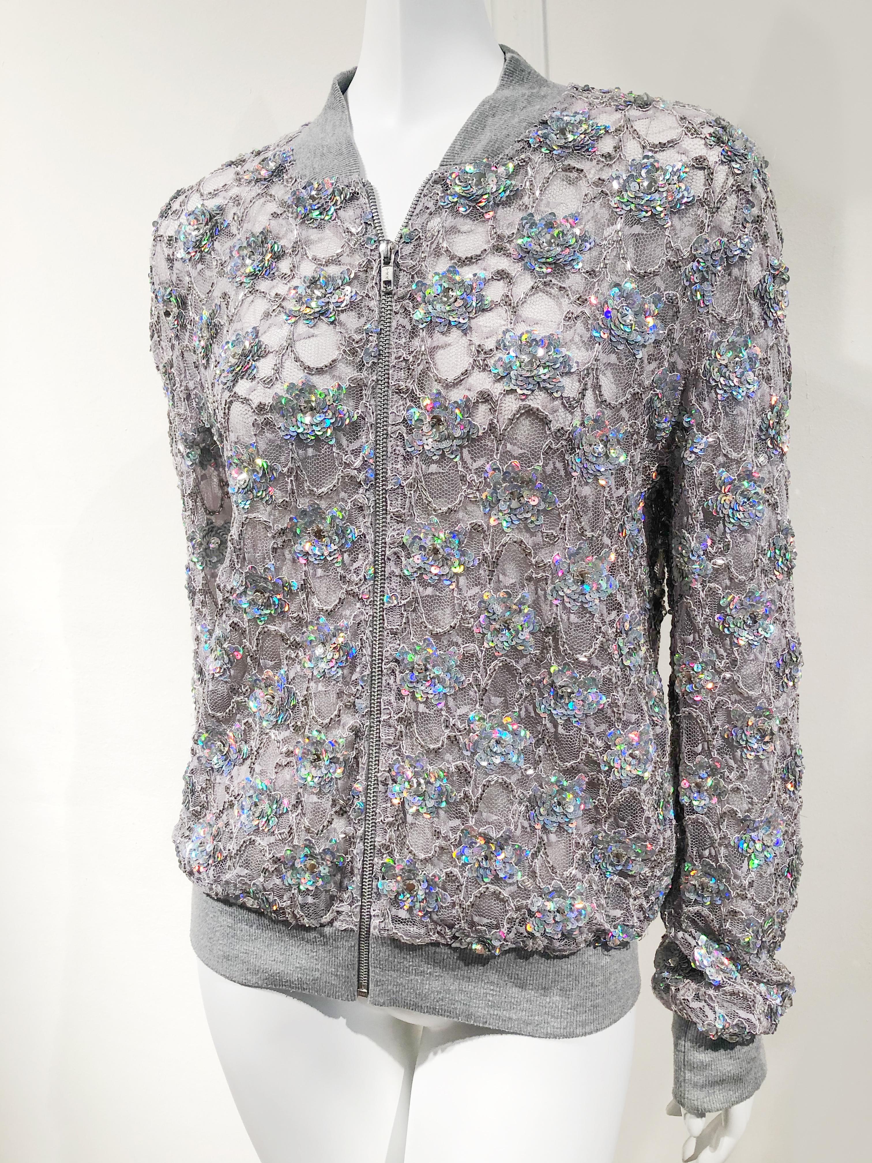 Sporty gray lace zippered bomber jacket with iridescent sequin hand embellishments by Ashish. Knit cuffs, collar and hem. Size Medium.
Condition
New without tags. Excellent condition.