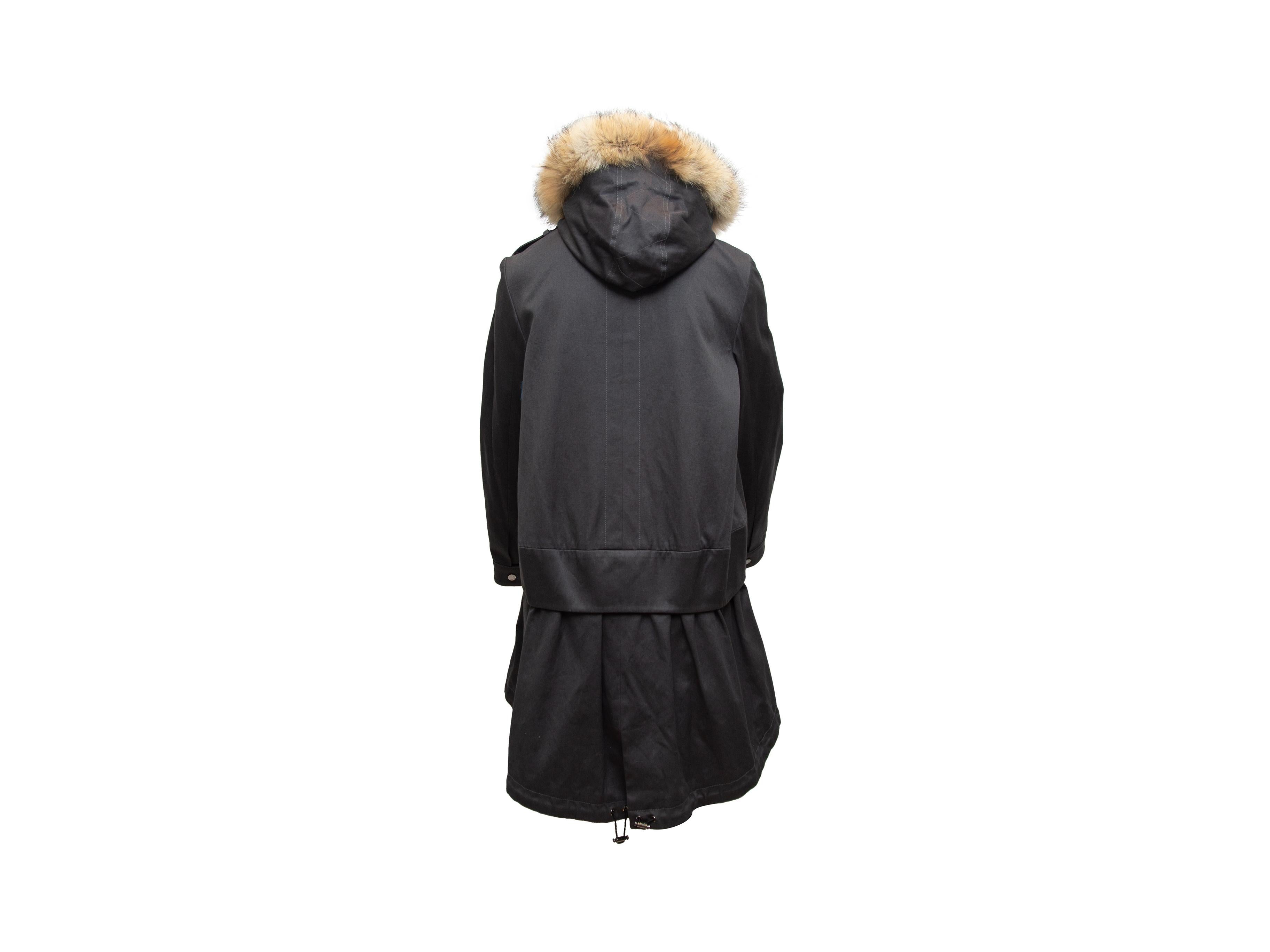 Product details: Grey cotton parka by Ashley B. Fur-trimmed hood. Dual hip pockets. Zip and snap closures at front. 39