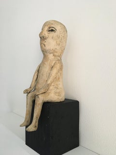 Ceramic figure on wood block: 'Enough of this'