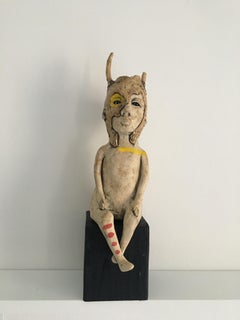Ceramic figure on wood block: 'Hunter gatherer Love'