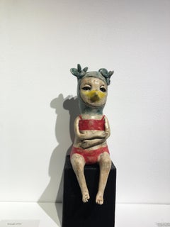 Ceramic figure on wood block: 'Take me to the sea'