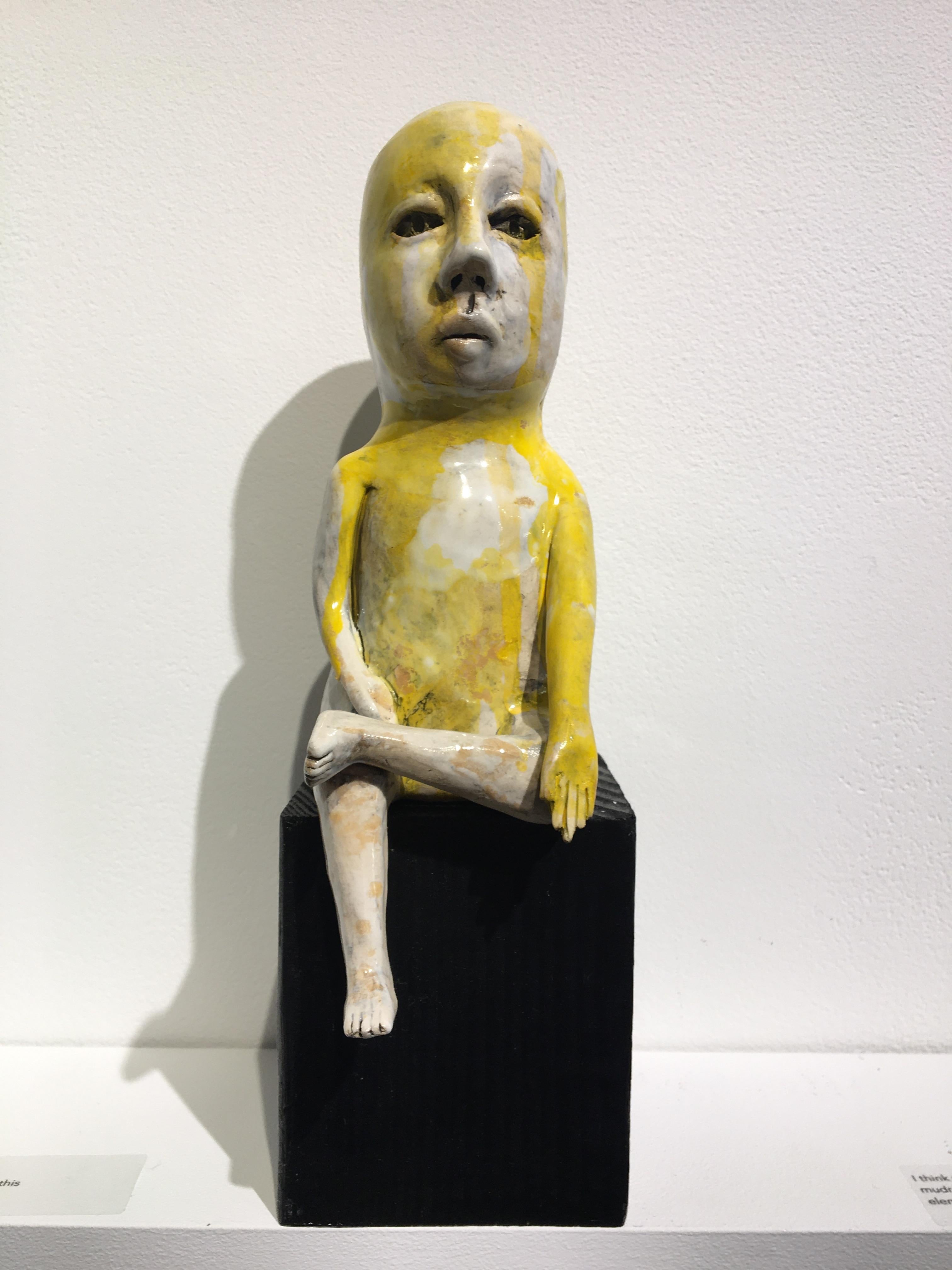 Ashley Benton Figurative Sculpture - Ceramic figure on wood block: 'Varada mudra boy'