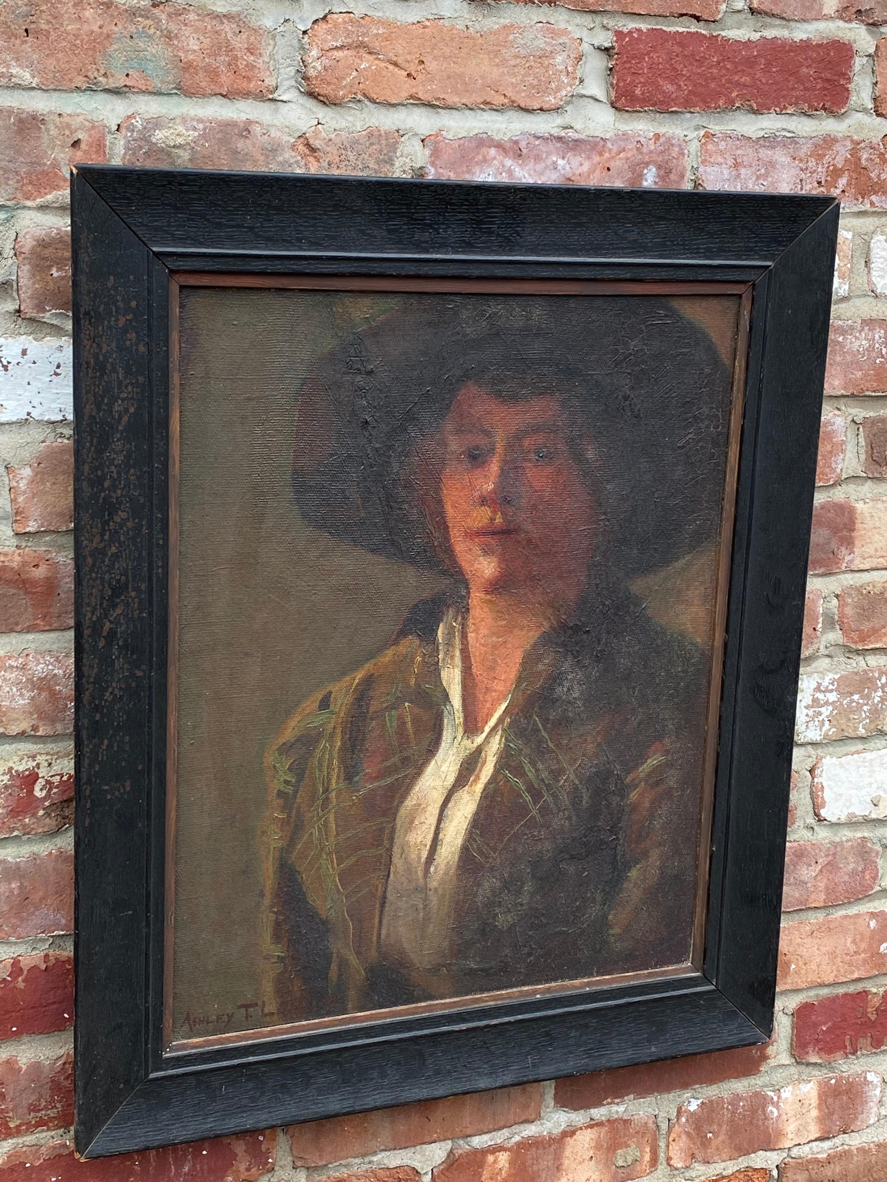 Moody portrait of a woman by Ashley T. Law, circa 1913. Woman in a wide brim hat done 3/4 pose. Bathed in light and shadow. The artist, Ashley Law, had quite the life as an artist, reverend and WW I veteran. Law also had painted the 1976 portraits