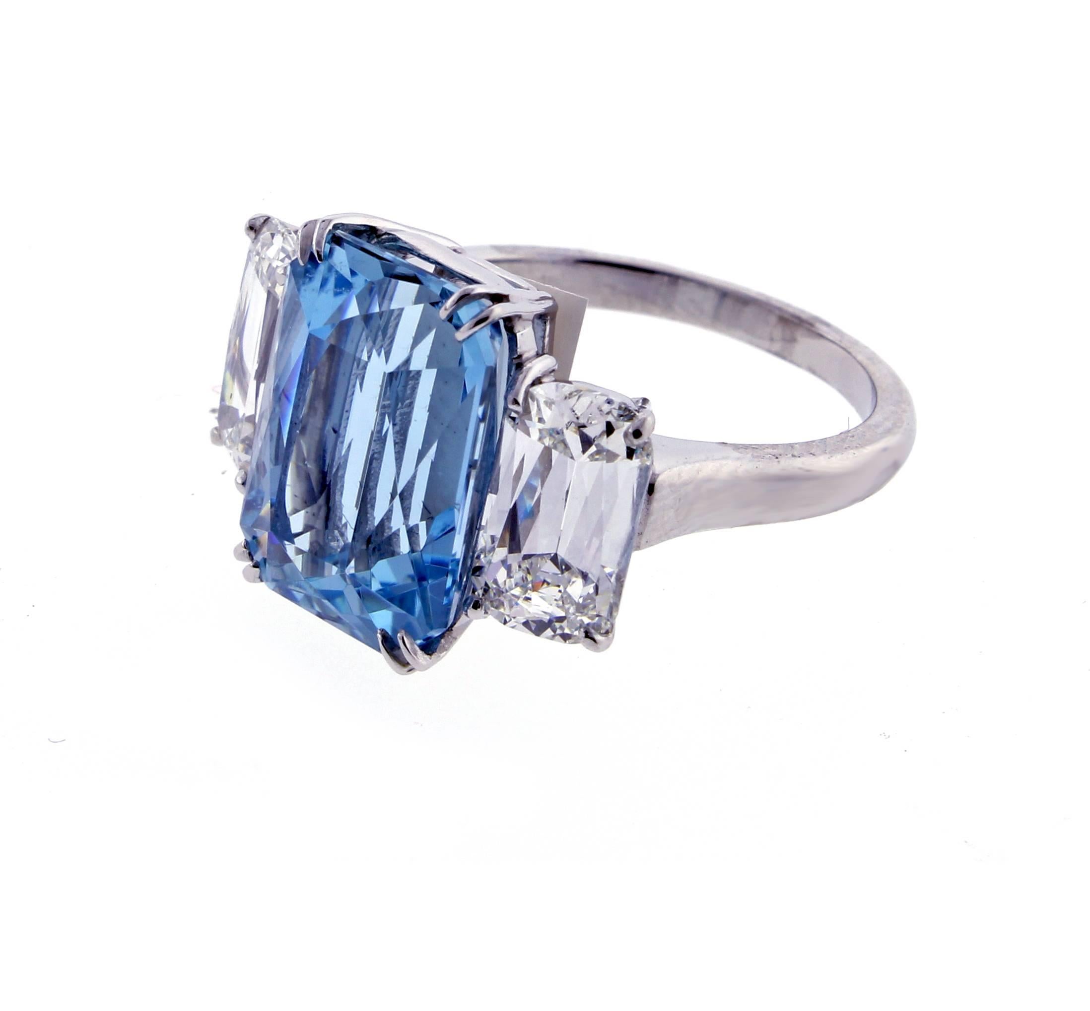 A Santa Maria aquamarine is paired with two of Ashoka cut diamonds creating a ring of unparalleled beauty.   The aquamarine weighs 6.85 carats. The two Ashoka G.I .A. certified diamonds weigh 1.38 and 1.44 carats and are H color and VS2, SI1