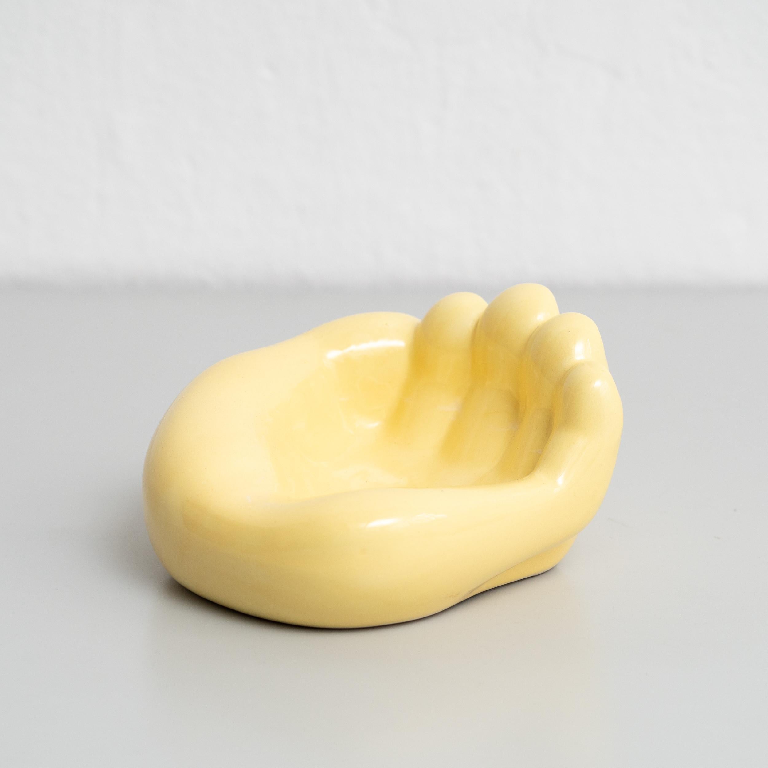 Immerse yourself in the sophisticated charm of mid-century modern design with this striking ashtray inspired by Georges Jouve. Crafted in France around 1950, this ceramic ashtray showcases the form of a large hand, adding a touch of whimsy to
