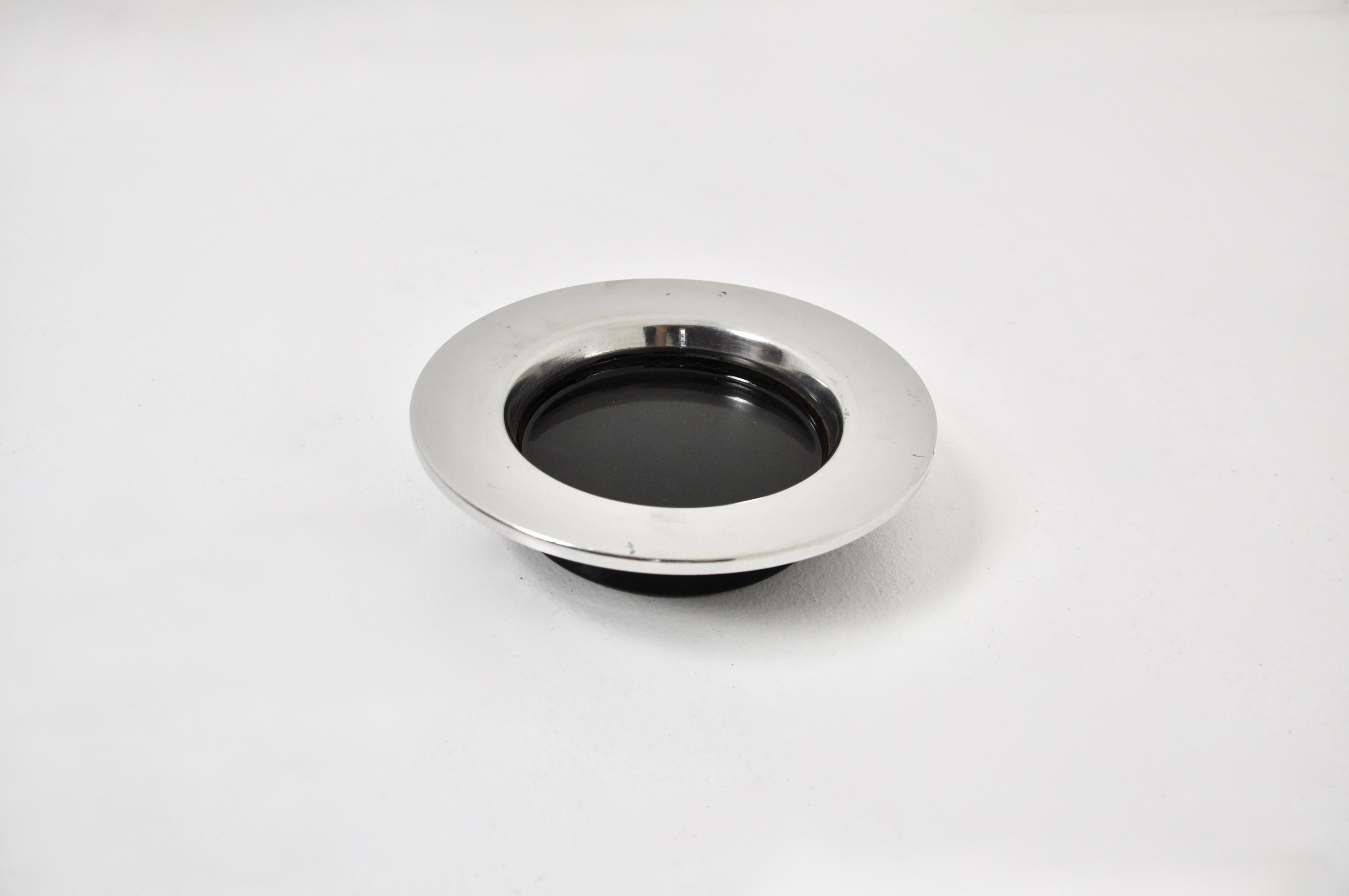 Black plastic and chromed metal ashtray. Stamped on the bottom. Wear due to time and age of the ashtray.