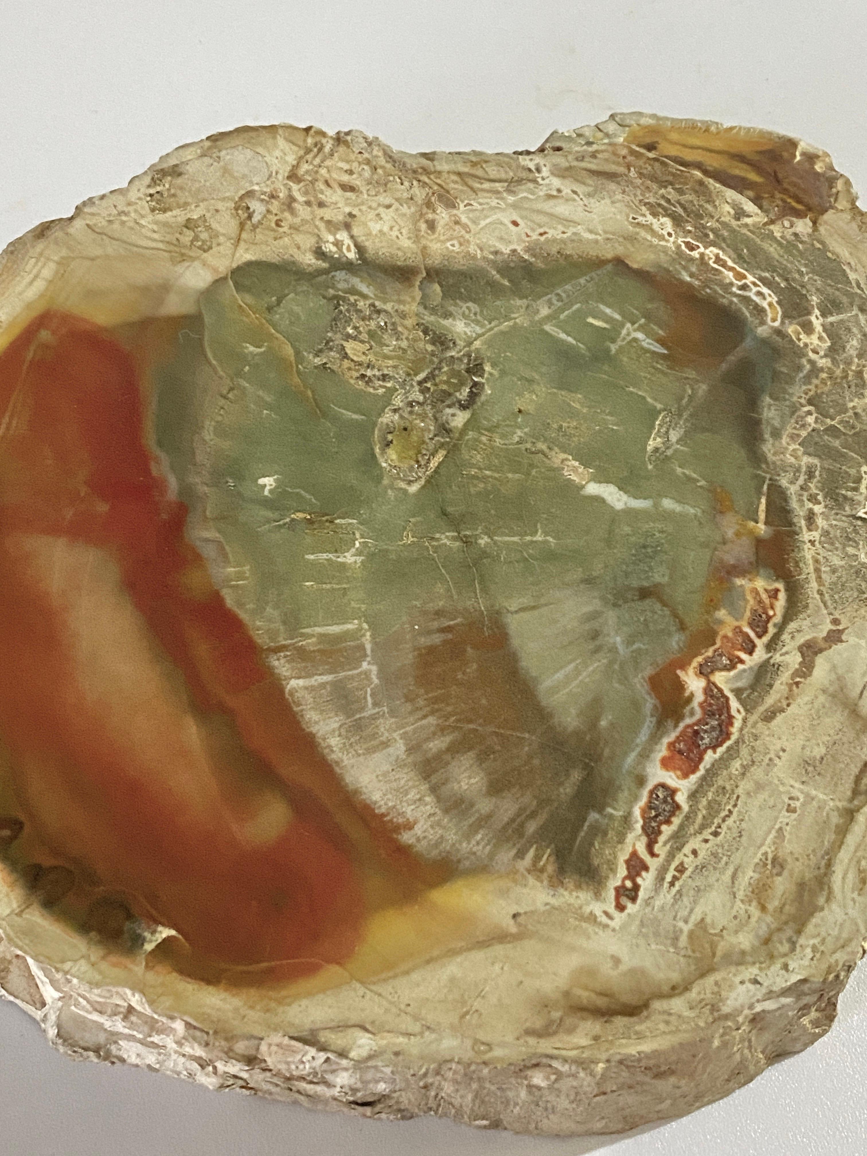 This is an ashtray, in beige, red color, good condition. It is dated from a few hundreds years. It is an organic modern item.


