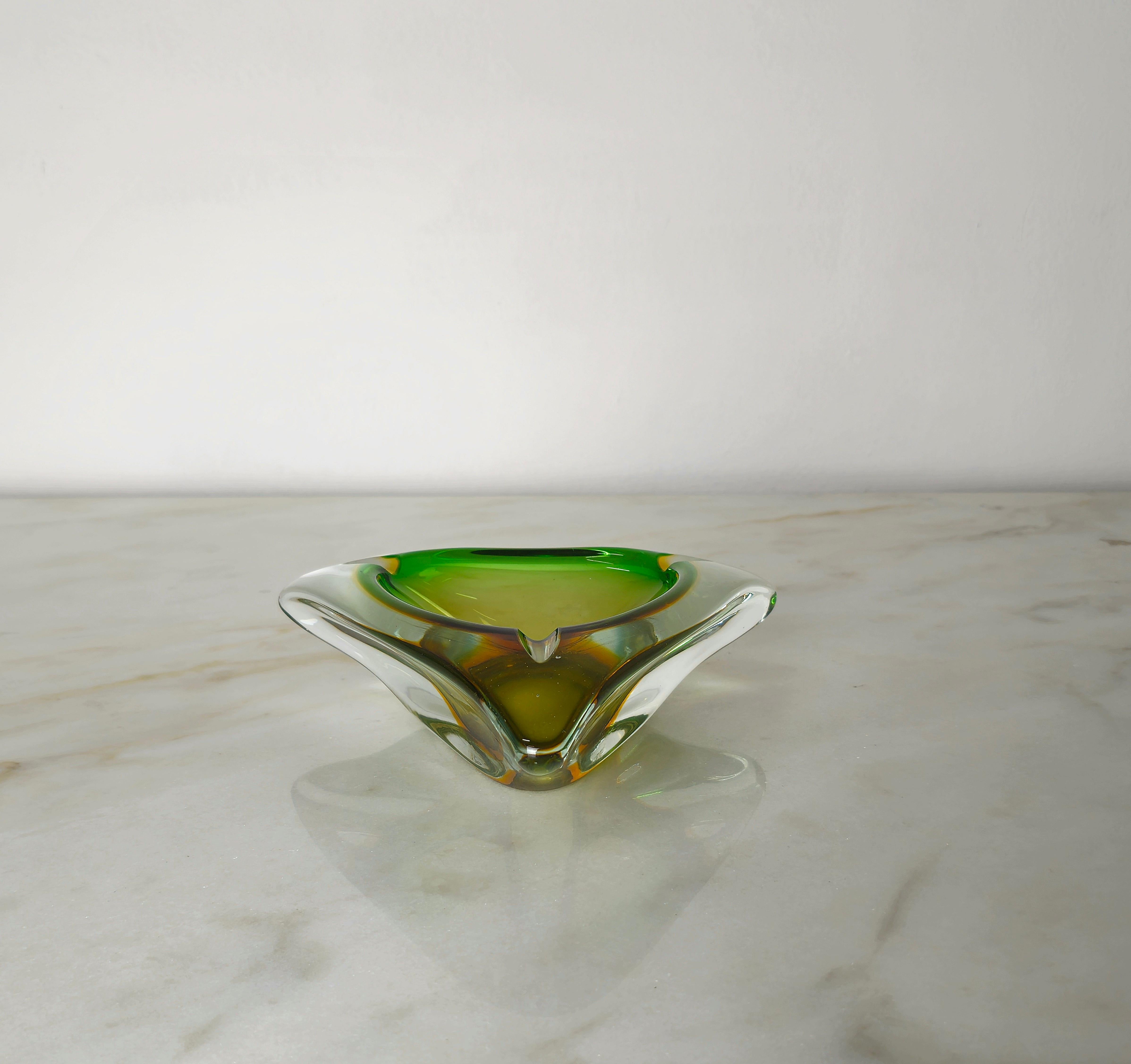 Triangular shaped ashtray made of submerged Murano glass in shades of transparent, amber and green. Made in Italy in the 70s.



Note: We try to offer our customers an excellent service even in shipments all over the world, collaborating with one of