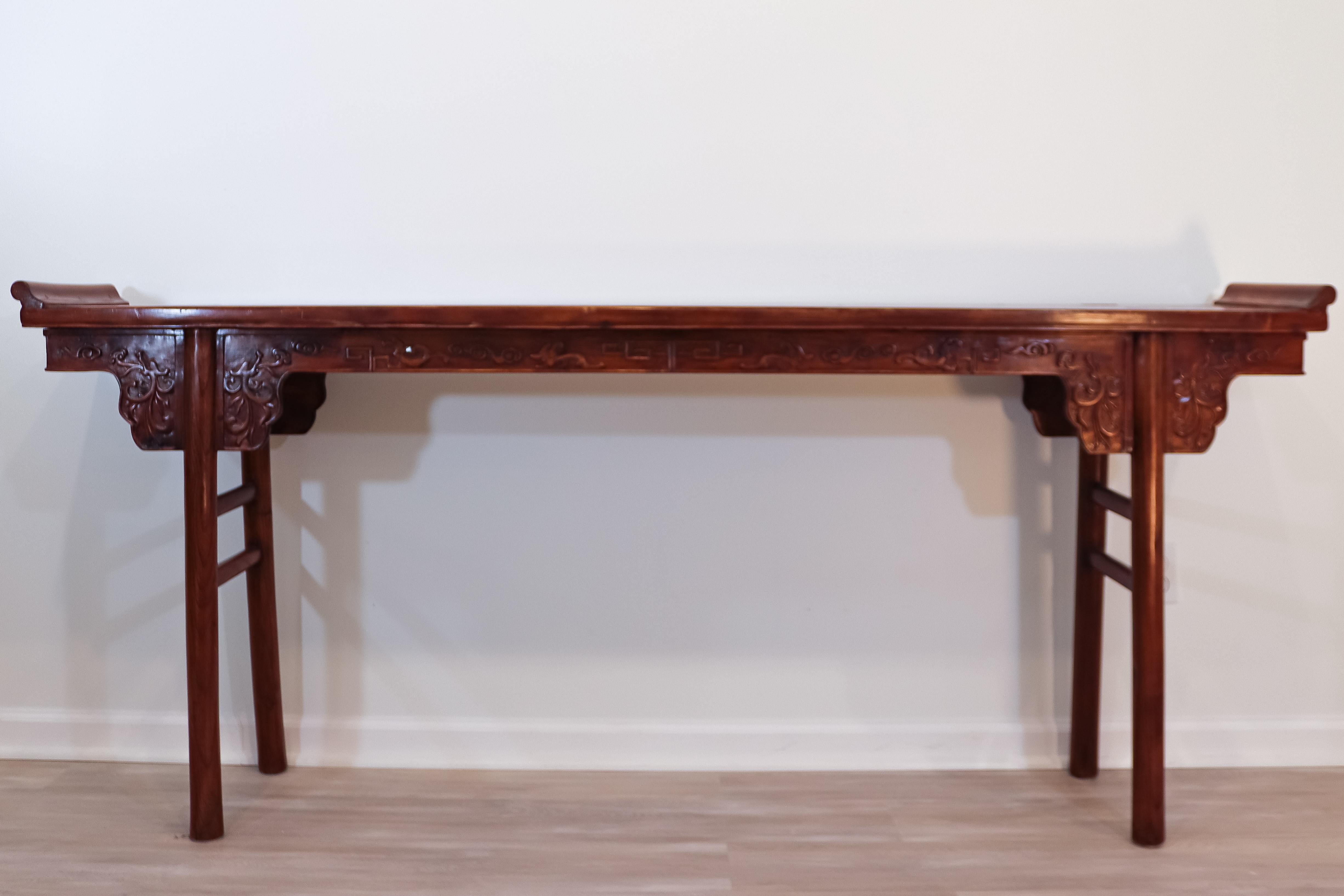 Fantastic Asian style alter table that would look stunning in any entry way or living space. The carved detail is contrasted by the simple, modern legs that would work well in any aesthetic.

In very good condition, with little or no imperfections.