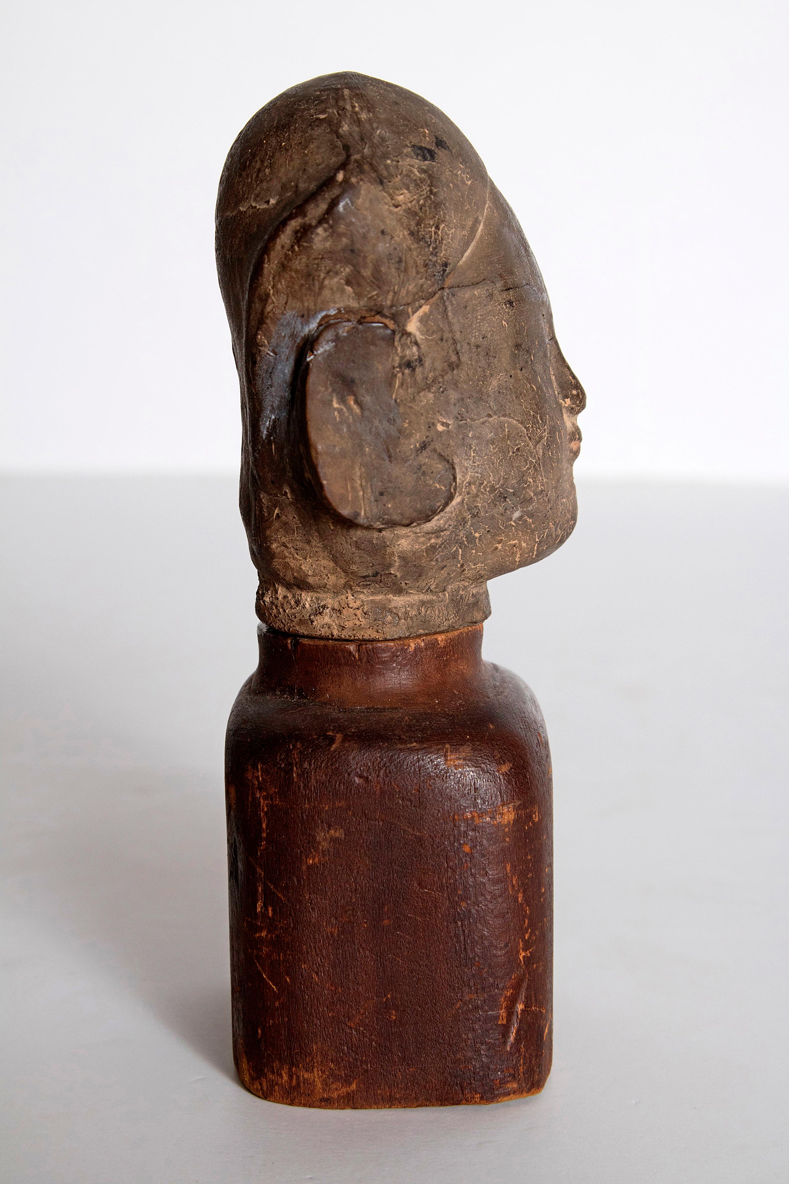 Asian Antiquity Clay Head on Wood Base In Distressed Condition In Dallas, TX