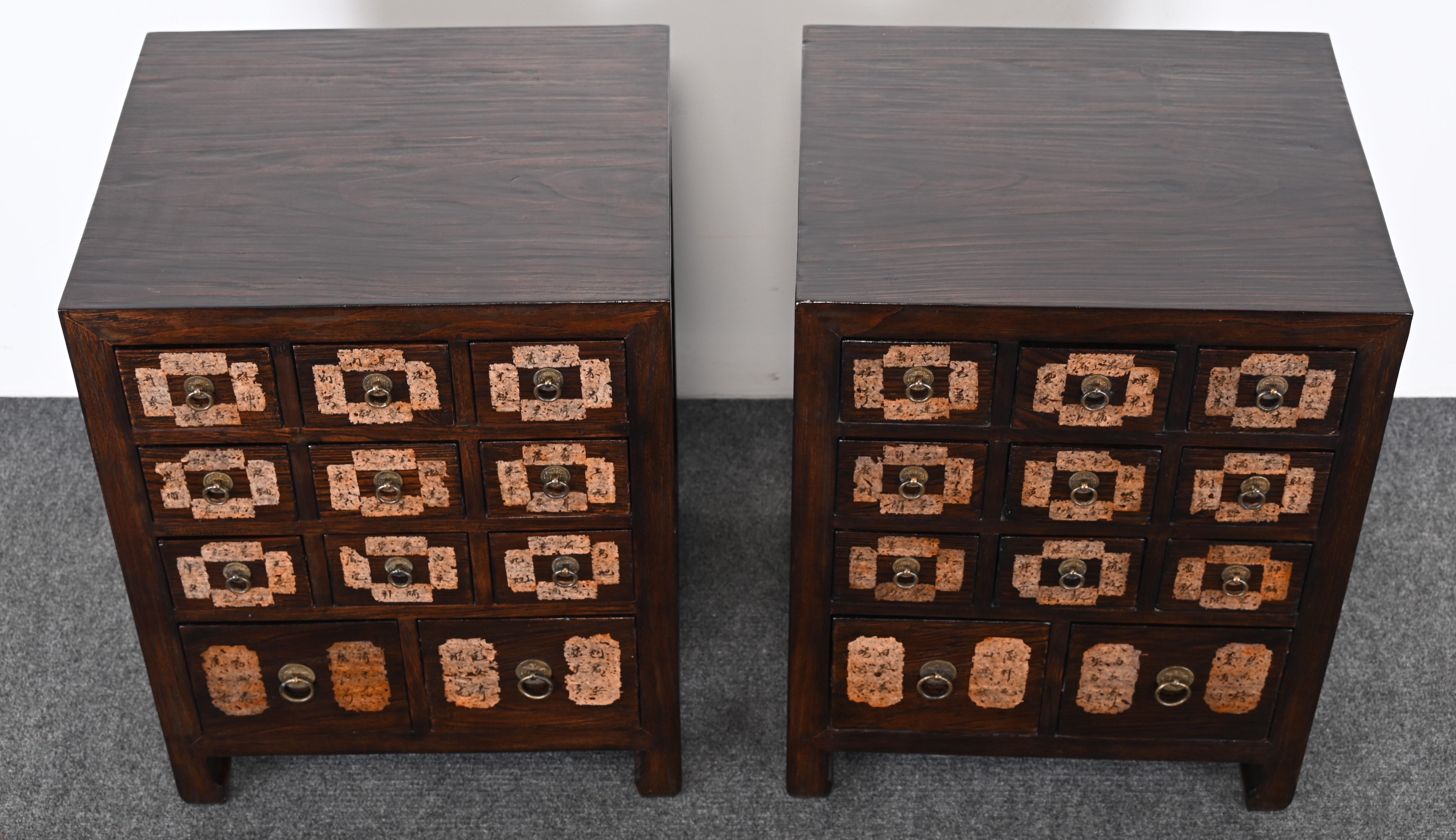 A unique pair of Chinese Apothecary Sidetables or Bedside Tables with multi-drawers made of Elmwood, Chinese paper, and brass medallion hardware or drawer pulls. The Asian cabinets or end tables are functional and can be great storage for a bedroom