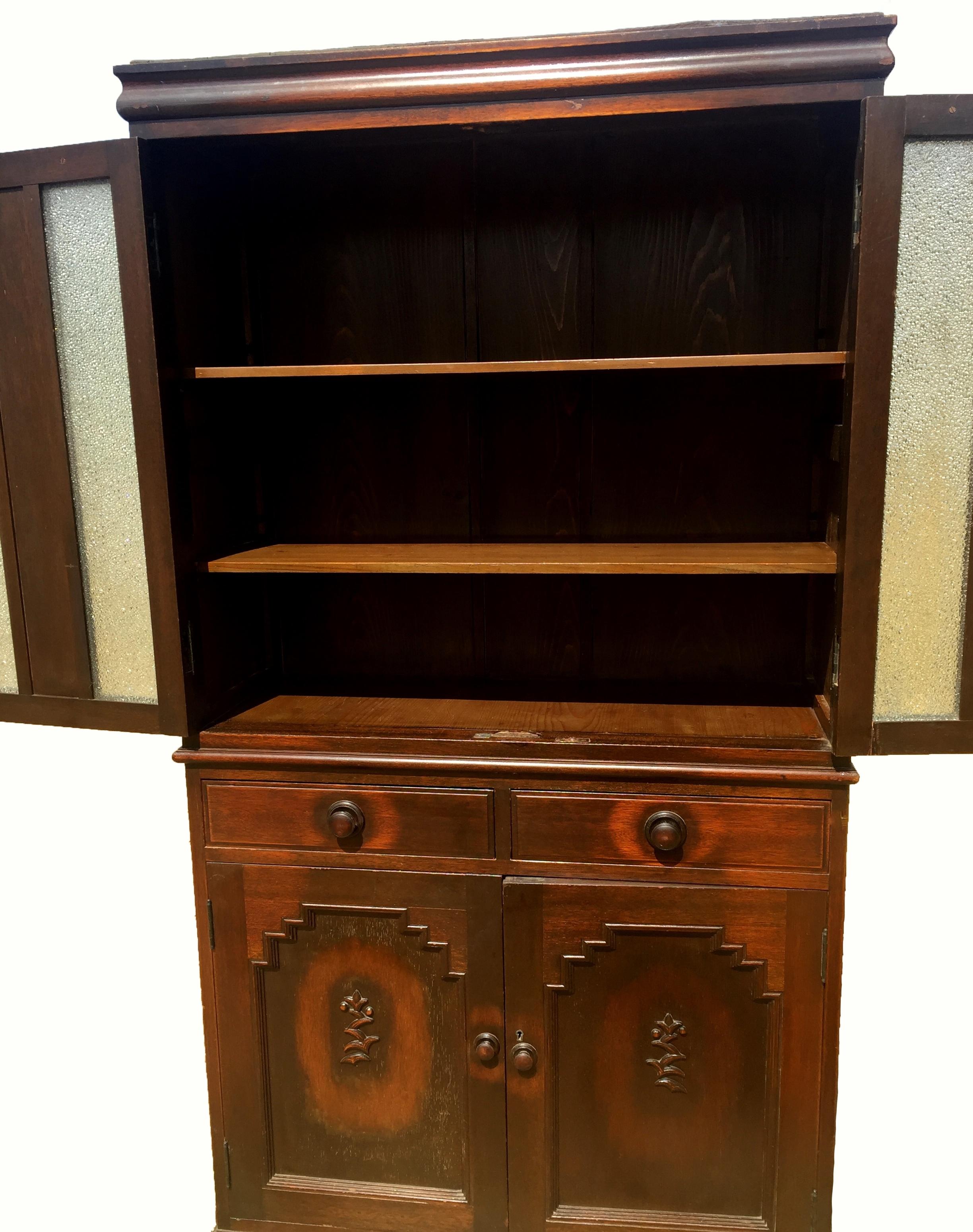 A rare Art Deco style cabinet from the China's republic era. The two tiered cabinet comprises of a lower chest with 2 drawers and 2 shelves, and a top chest with 2 shelves. The top doors with rare diamond glass panels sparkle brilliantly. The lower