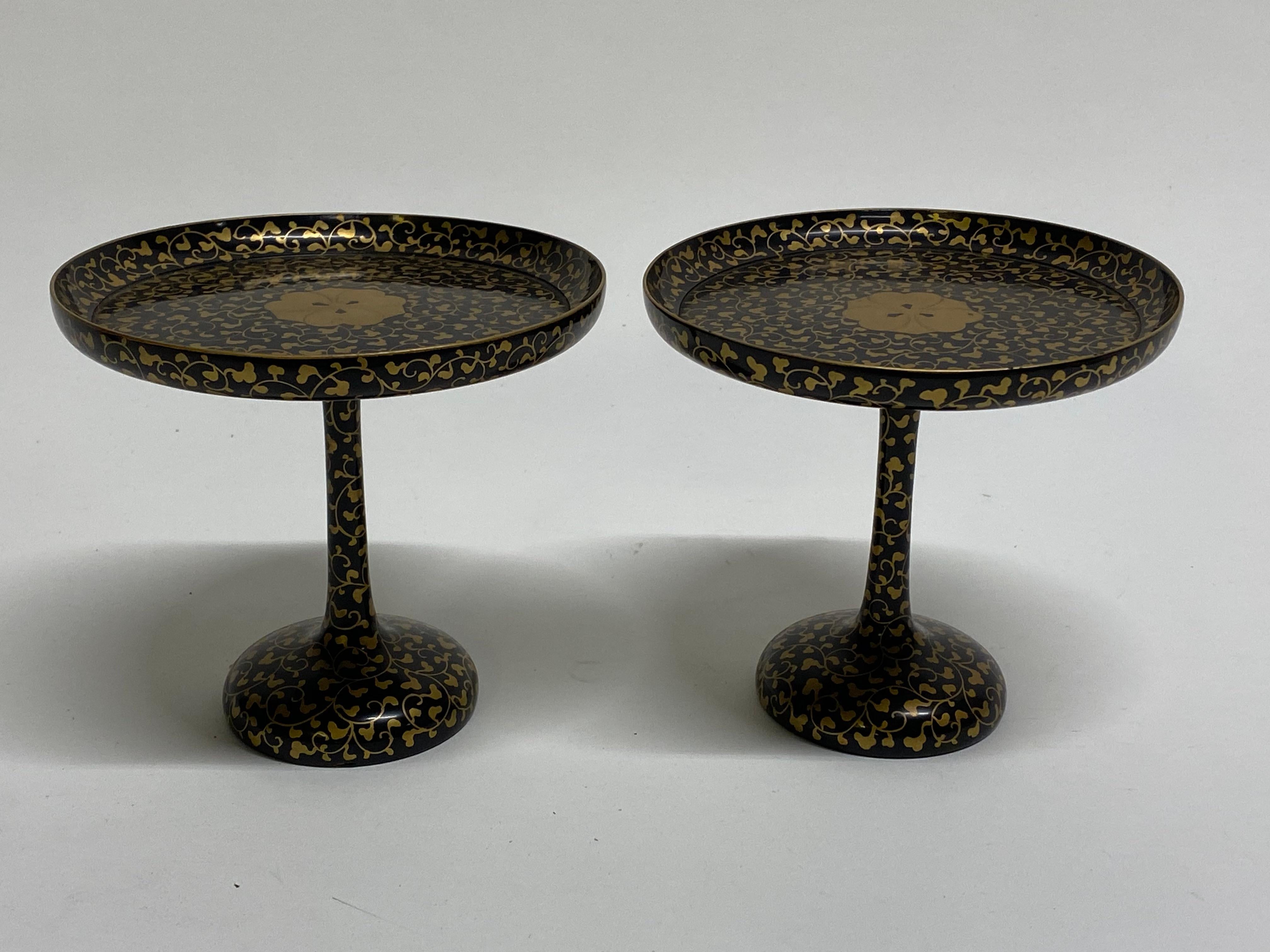 A simply gorgeous pair of Asian black lacquer and gold leaf floral decorated tazzas. A tazza can be just for decorative value, while a compote is used to hold something such as food. Delicate and beautiful hand decorated wood. Intricate interlacing