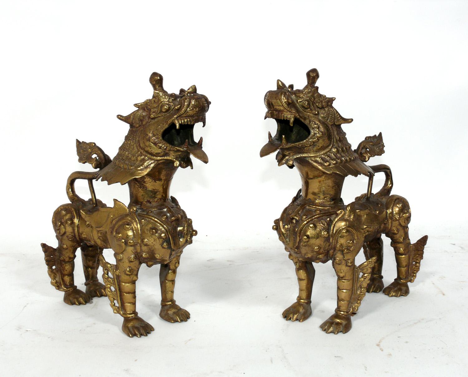 Pair of Asian Bronze Foo Dogs or Kylin Dragon, probably Tibetan, circa 1940s or earlier. They retain their warm original patina. These were purchased from the Manhattan estate of a Japanese American that traveled extensively through Asia in the