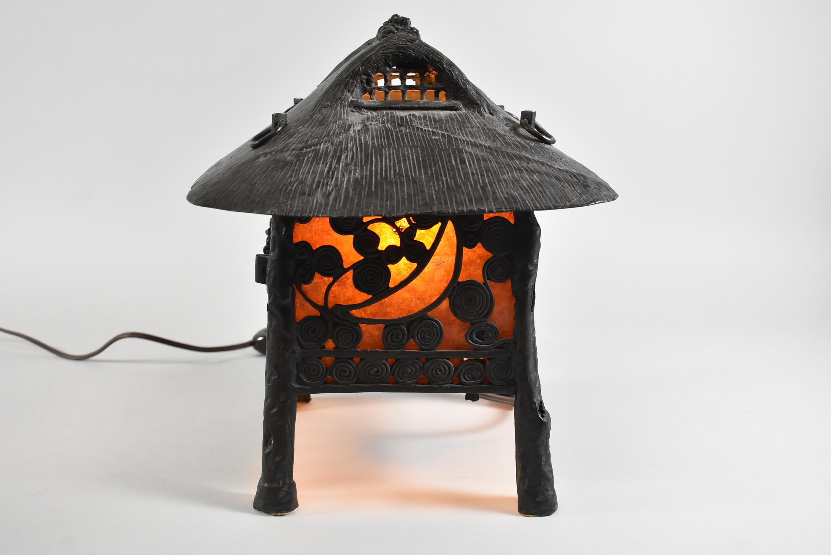 Unique small table lamp with an Asian design of spiderwebs and spiral swirls.  Mica panels, single socket and thumb switch on the cord.  Dimensions 11