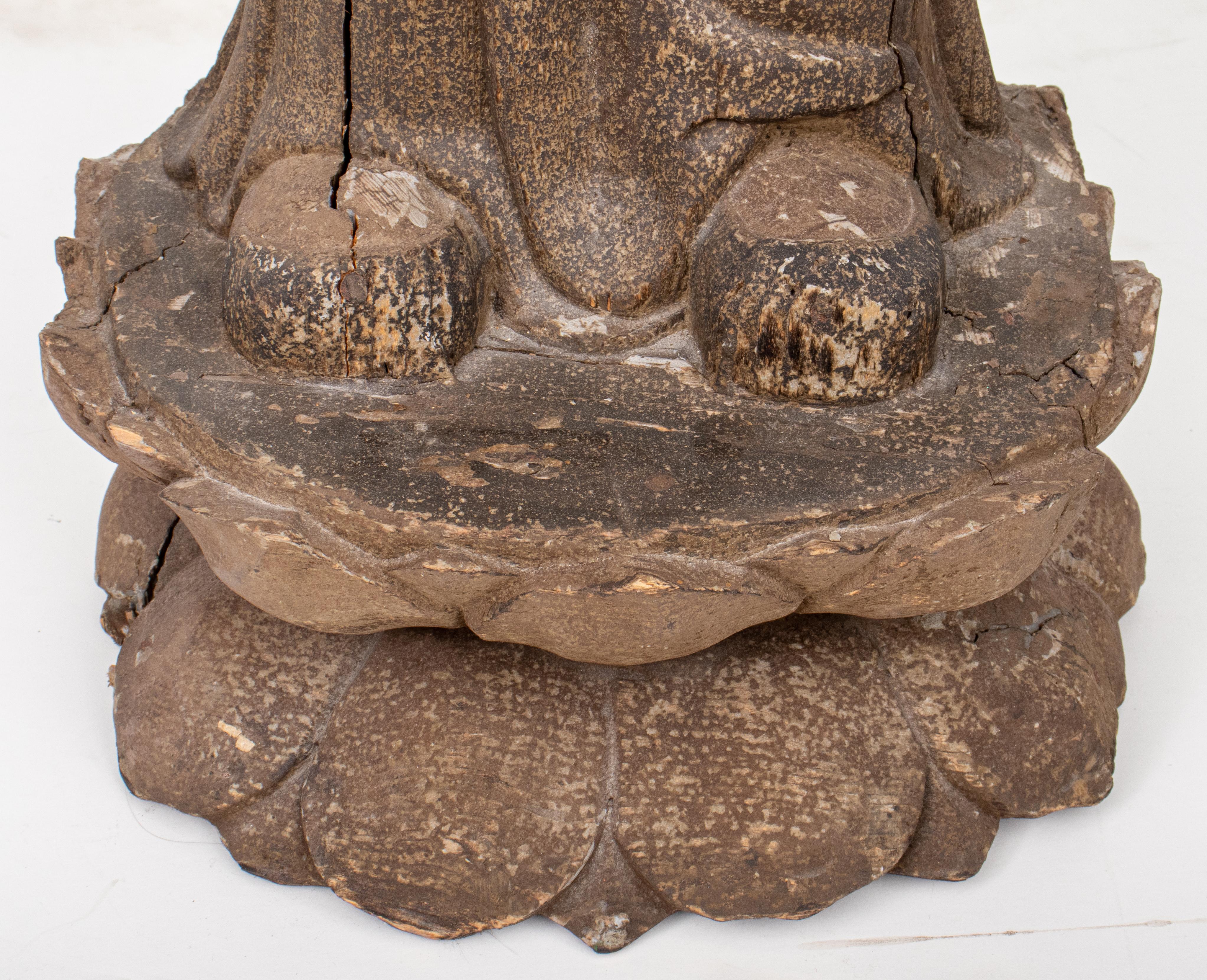 Polychrome painted hardwood statue of a male Buddhist monk with his hands in prayer position over his heart and standing upon a double lotus base. 
Dimensions: 39