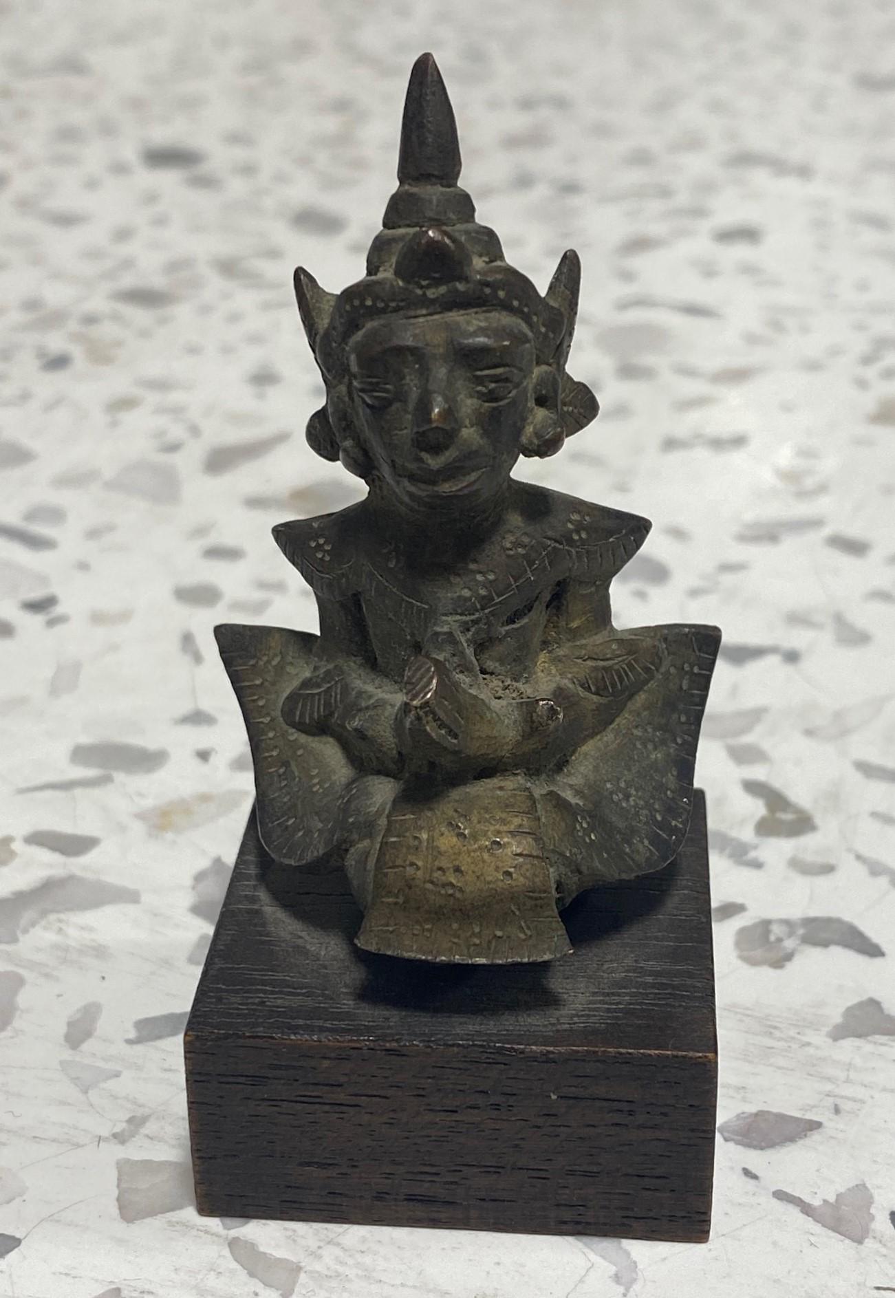 A beautiful small bronze Asian Buddhist or Indian Hindu praying deity figure on a wood stand.

This piece has a wonderful feel and presence to it.

From an extensive private Los Angeles collection of Asian art and artifacts. One of the best