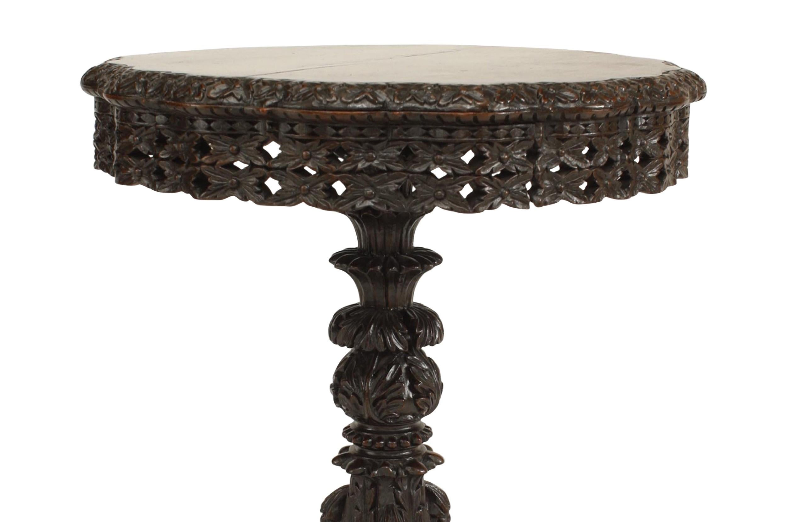 Table d'appoint asiatique de style birman (19e siècle) en bois de rose sculpté, à base de piédestal et plateau rond, avec tablier filigrané et 3 pieds.

Fissure sur le dessus, pièce fragile.