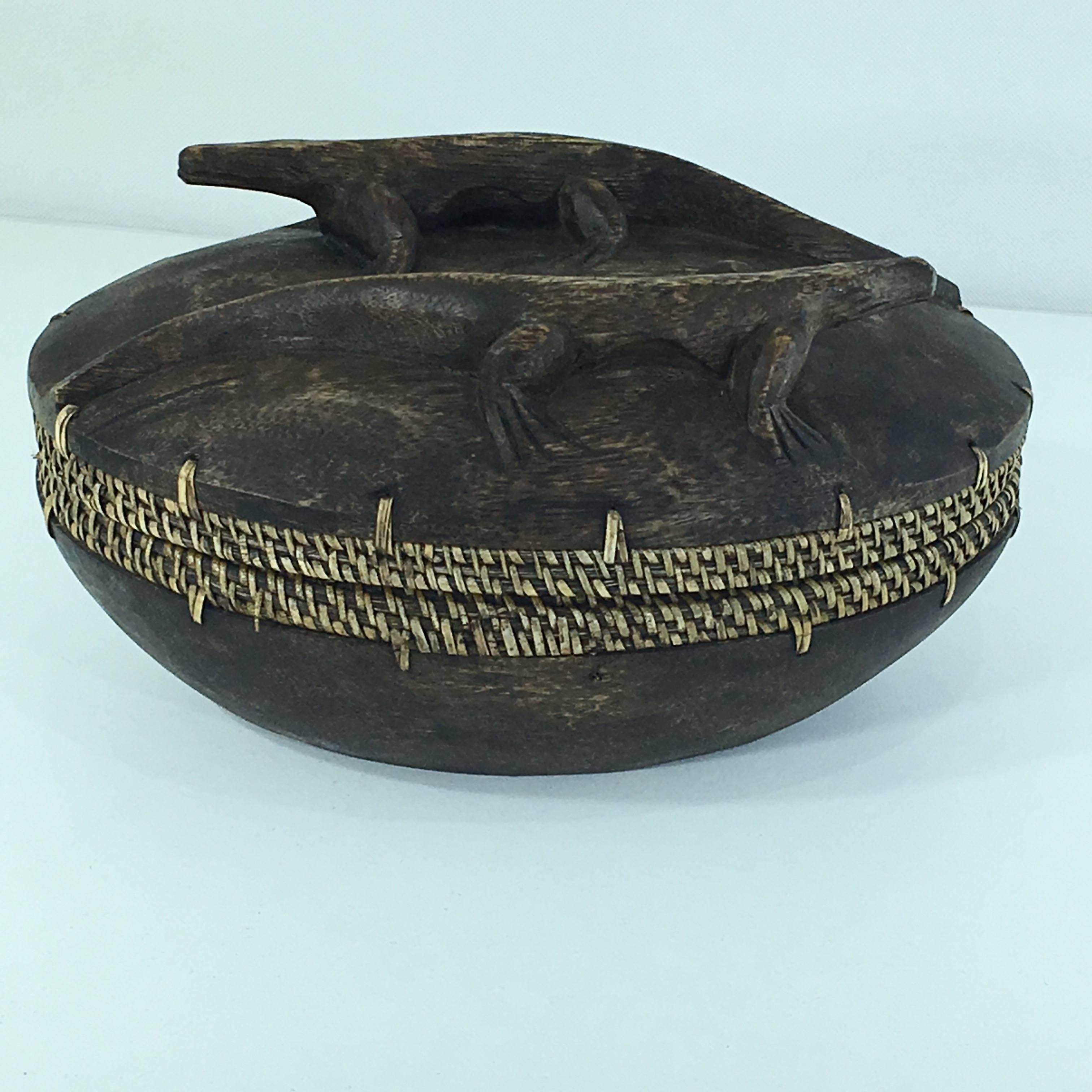 This box is from the Asian continent, made in the period, 1950-1960. We can see cane on the border, that gives an handmade authenticity and image to the item. It is in good condition, and the color is brown and kind of yellow. The sculpted animals