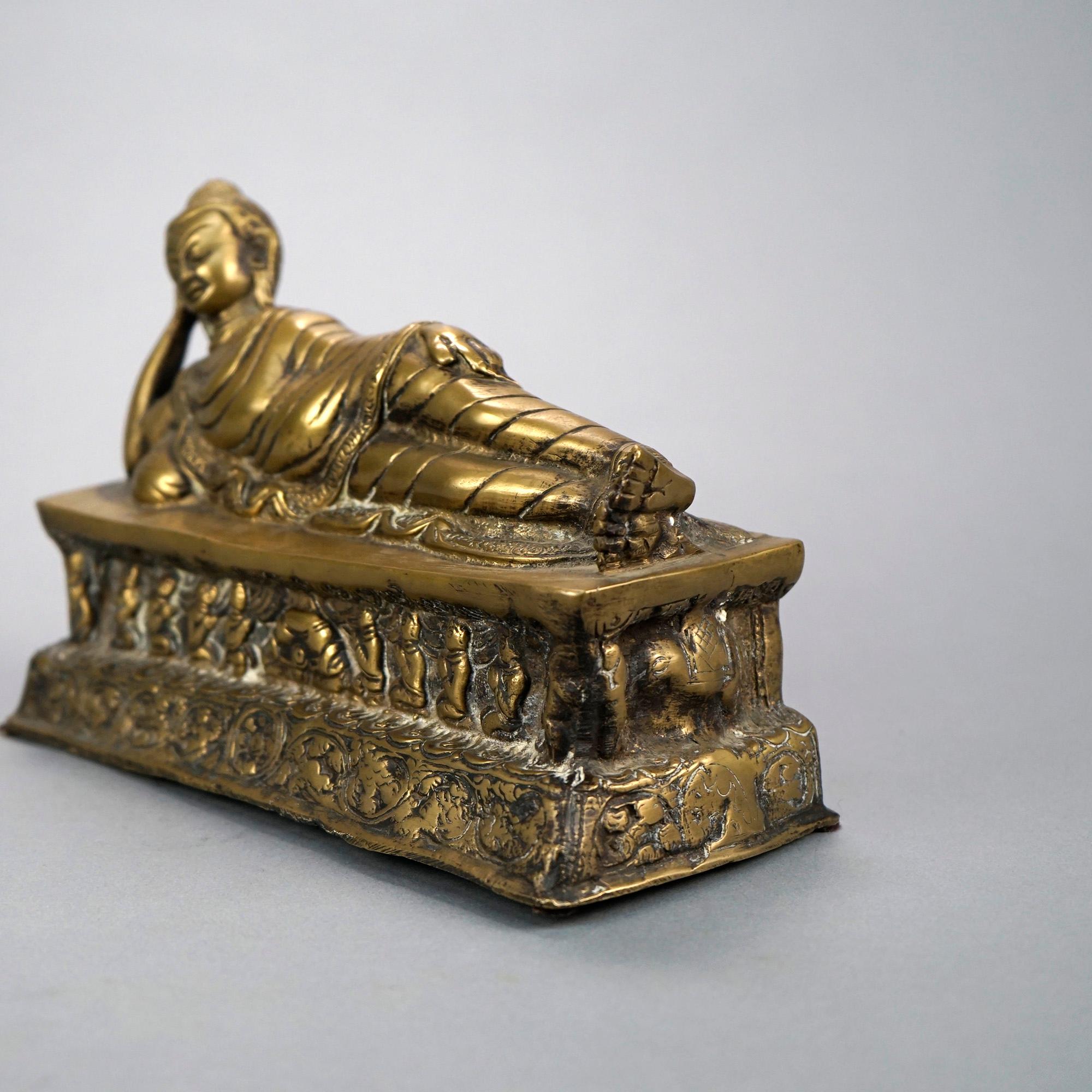 An oriental Asian cast bronze sculpture offers reclining Shiva on plinth having foliate and praying figures, 20th century

Measures- 6'' H x 9.5'' W x 4'' D.

Catalogue Note: Ask about DISCOUNTED DELIVERY RATES available to most regions within 1,500