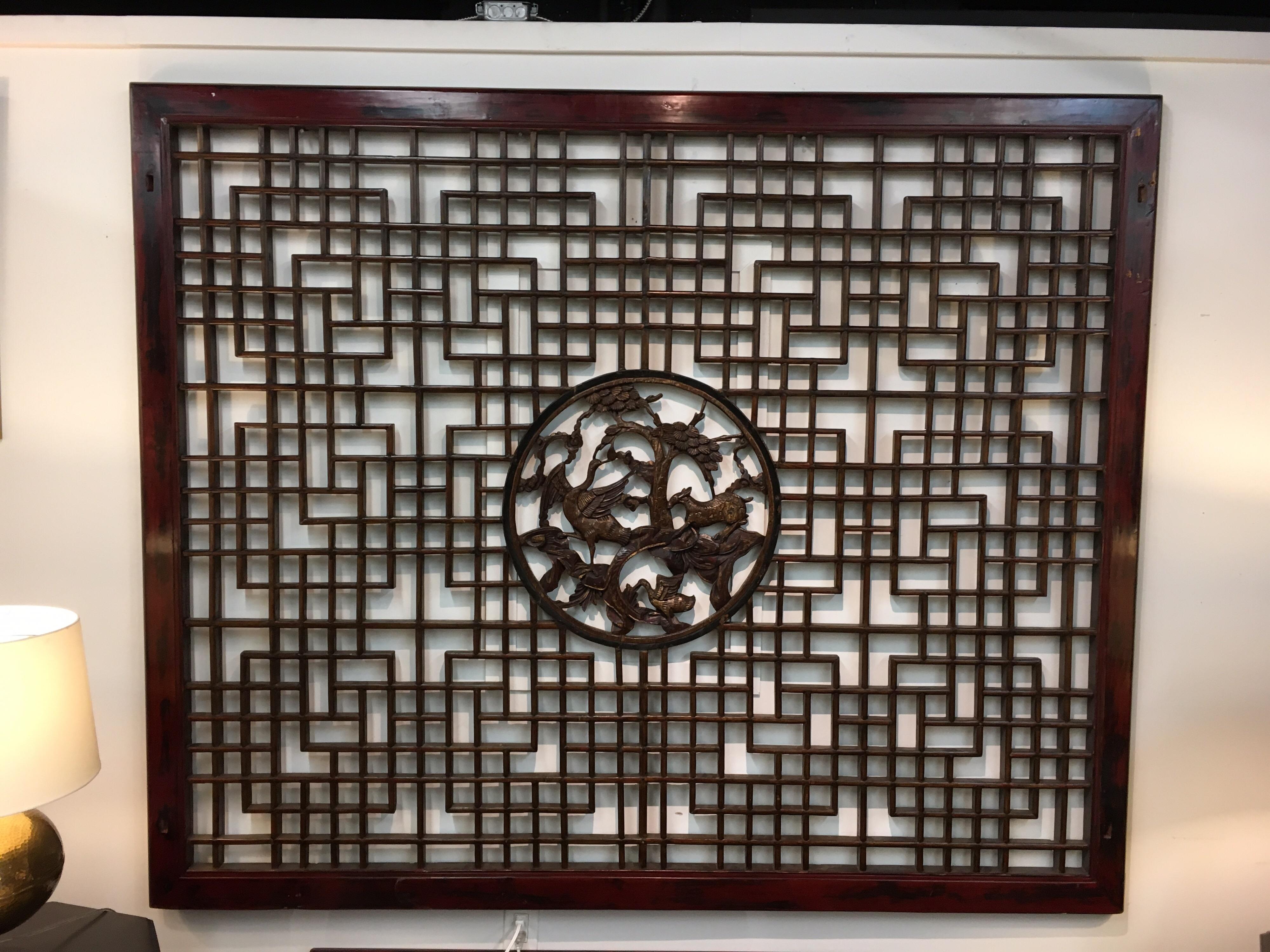 Stunning vintage Chinese large mahogany and elmwood latticed wall sculpture that is one of a kind.
It is large, dimensions are below, and has open fretwork throughout. The center has carvings that are nothing short of magnificent.