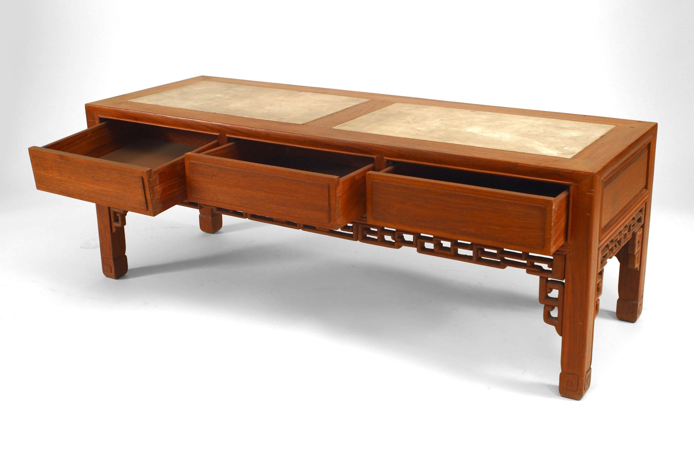 Asian Chinese style (20th century) rectangular teak coffee table with three drawers and two-piece inset marble top with filigree carved apron.
 