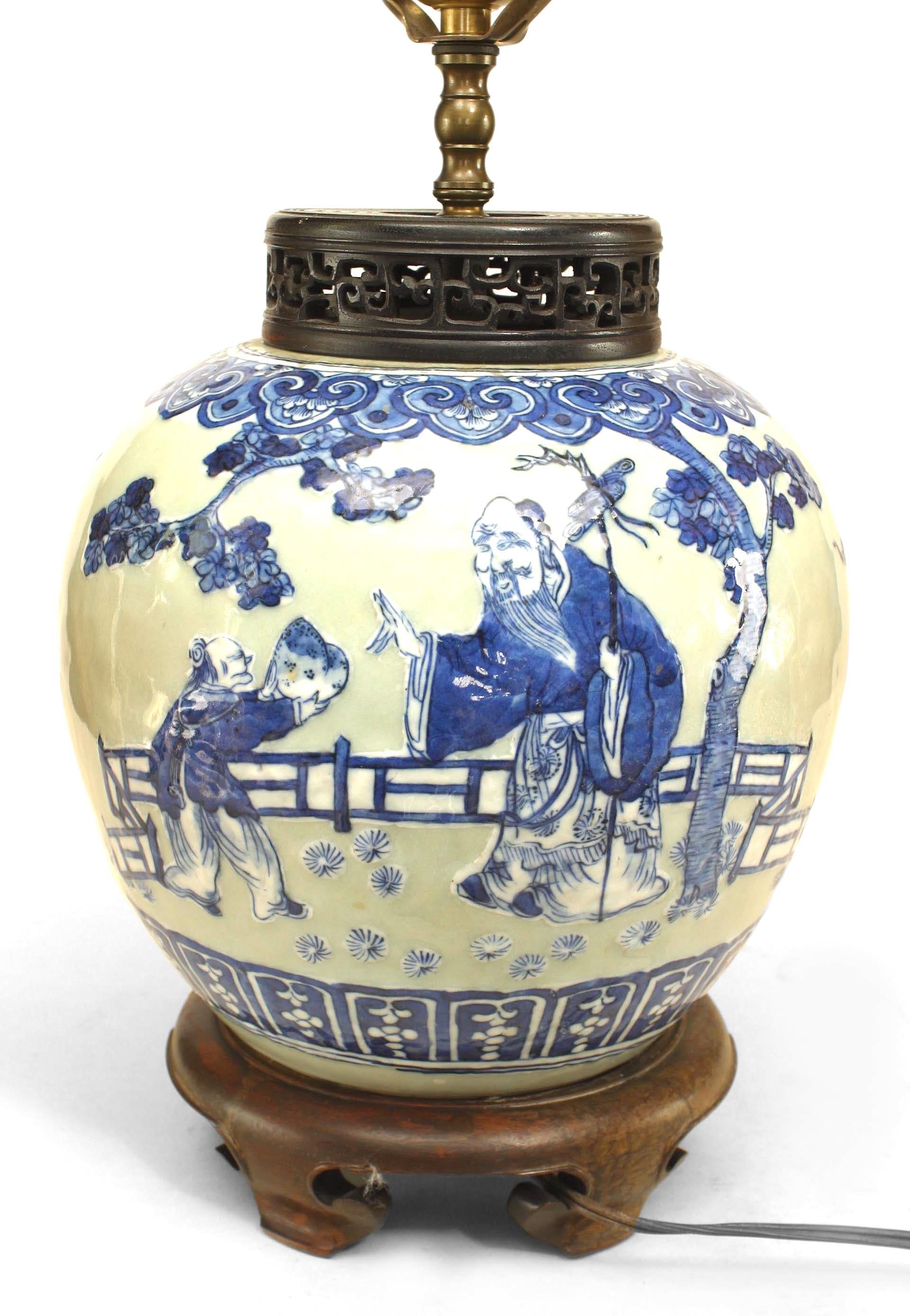 Asian Chinese style (19th Century) celadon porcelain lamp with blue figural scene and mounted on a round teak base and filigree cover.
