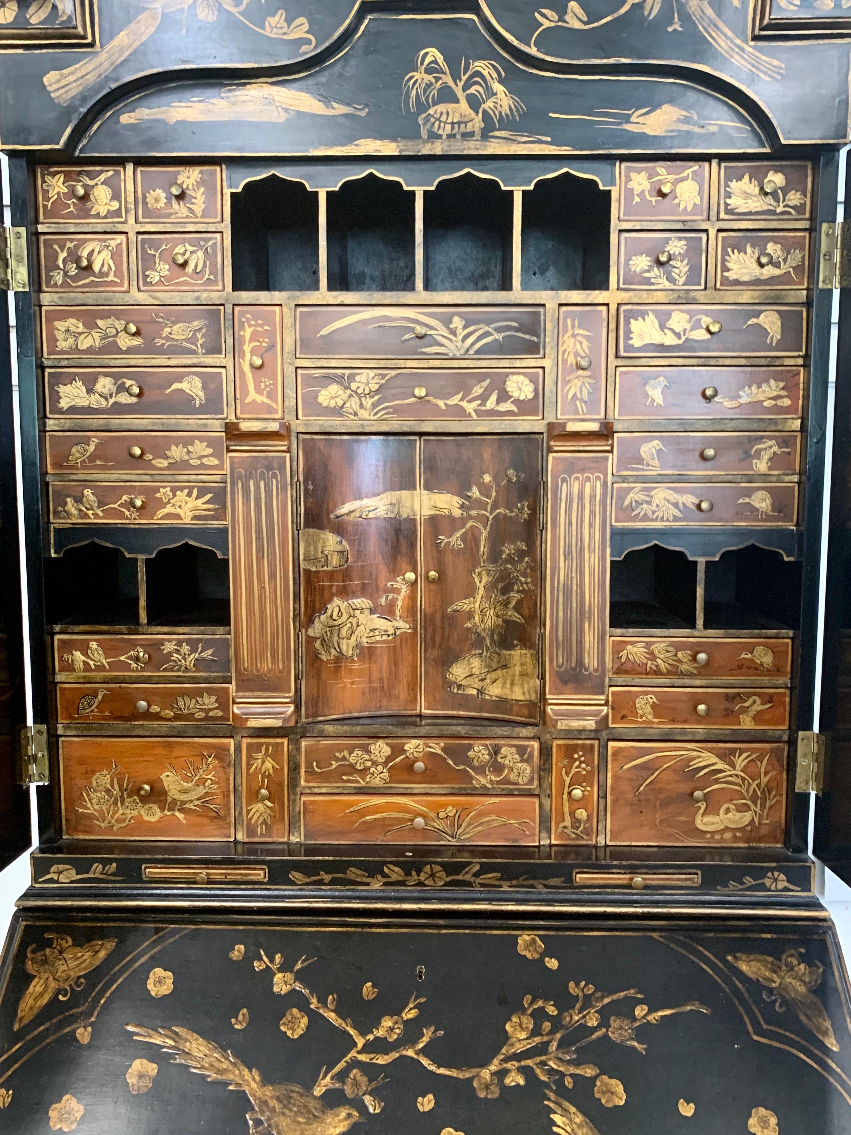 Stunning, one of a kind, vintage Asian black and gold lacquer chinoiserie secretary desk. What makes this secretaire so unusual is the raised birds and floral designs throughout and the incredible craftsmanship. There are multiple drawers and