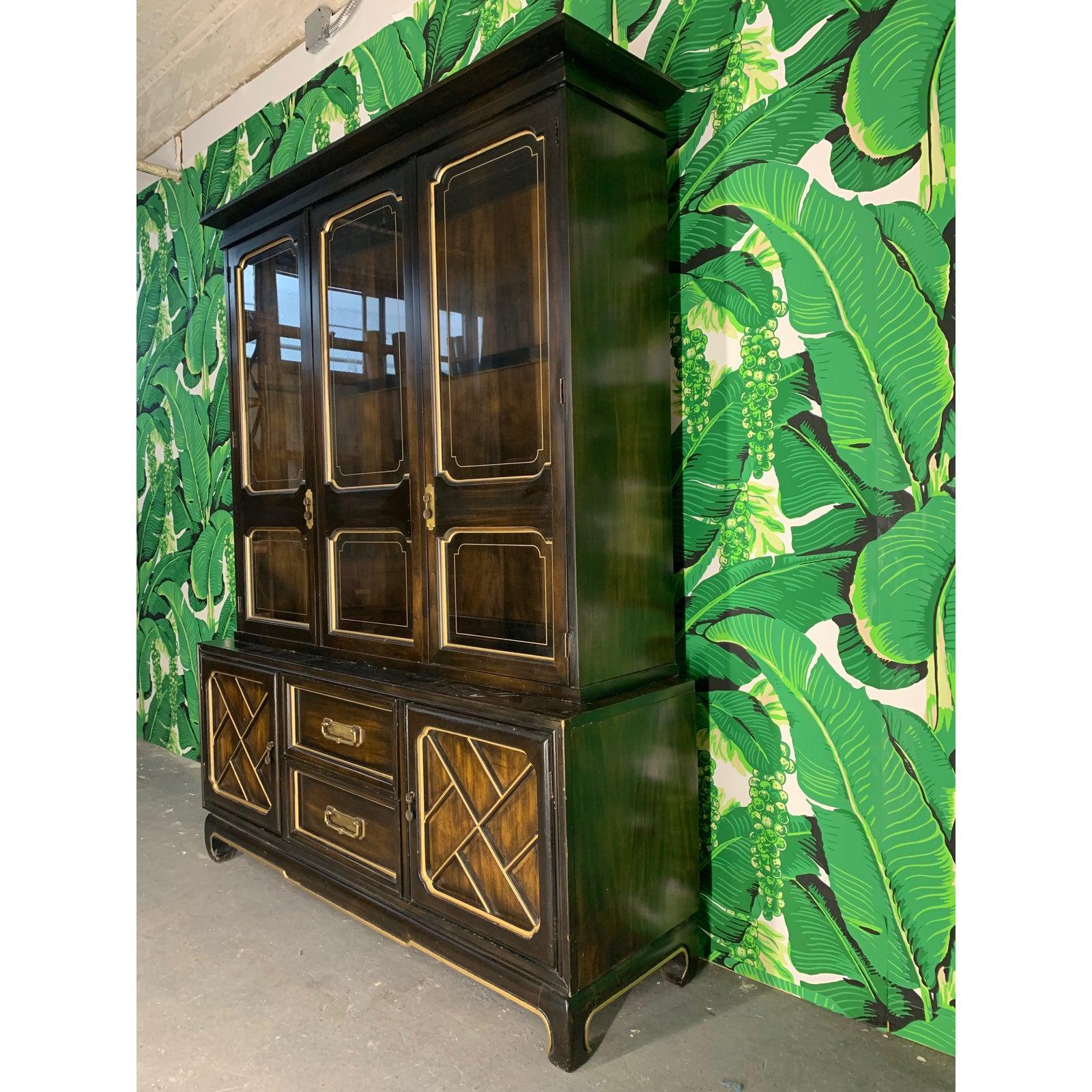 Asian style china cabinet features glass shelves and Chippendale style detailing outlined in gold. Very good vintage condition with minor imperfections consistent with age.

    