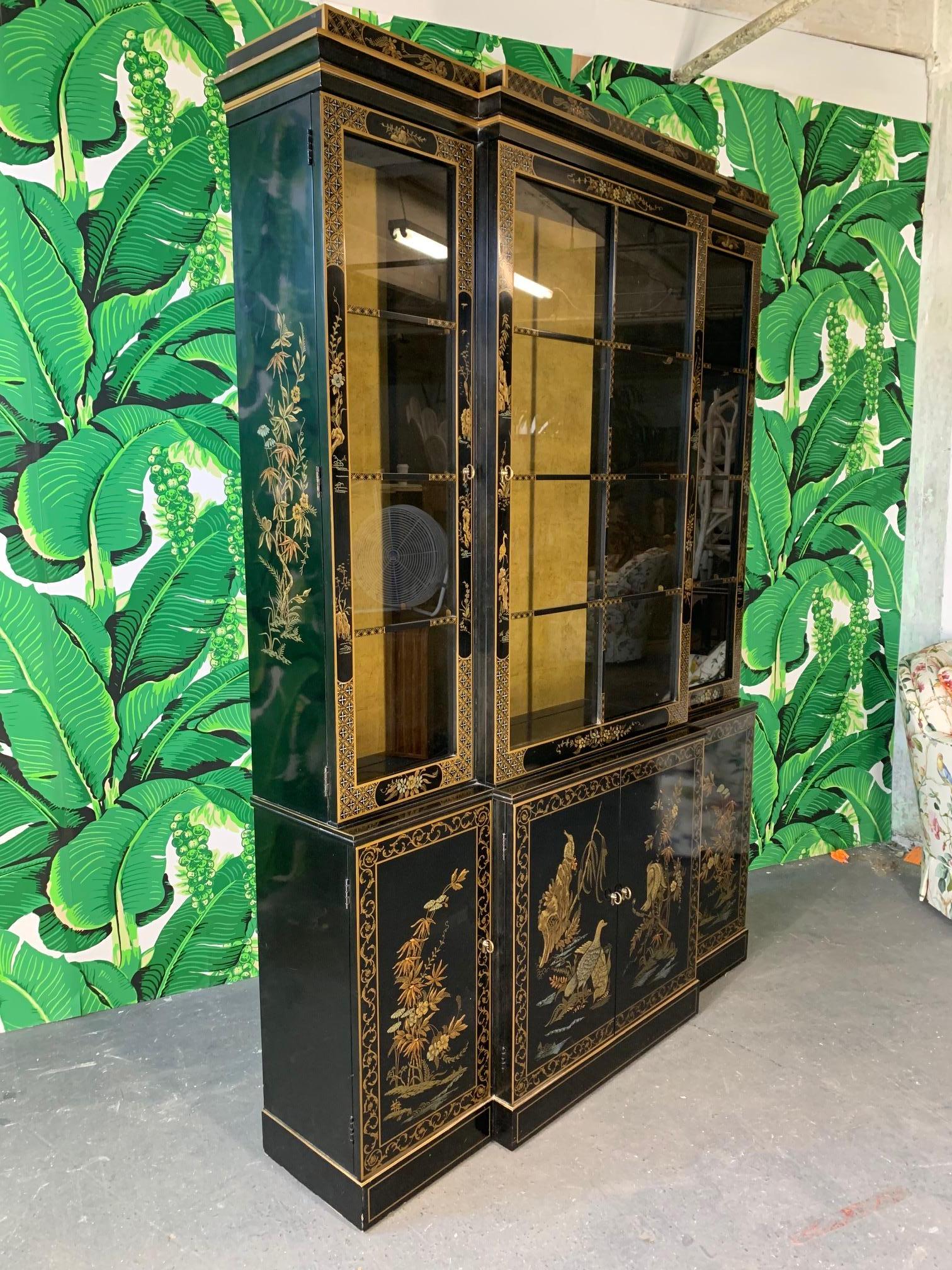 Black lacquered China cabinet by Drexel in Chinese chinoiserie style features hand painted murals and lighted interior with glass shelves. Very good condition with only very minor imperfections consistent with age.
