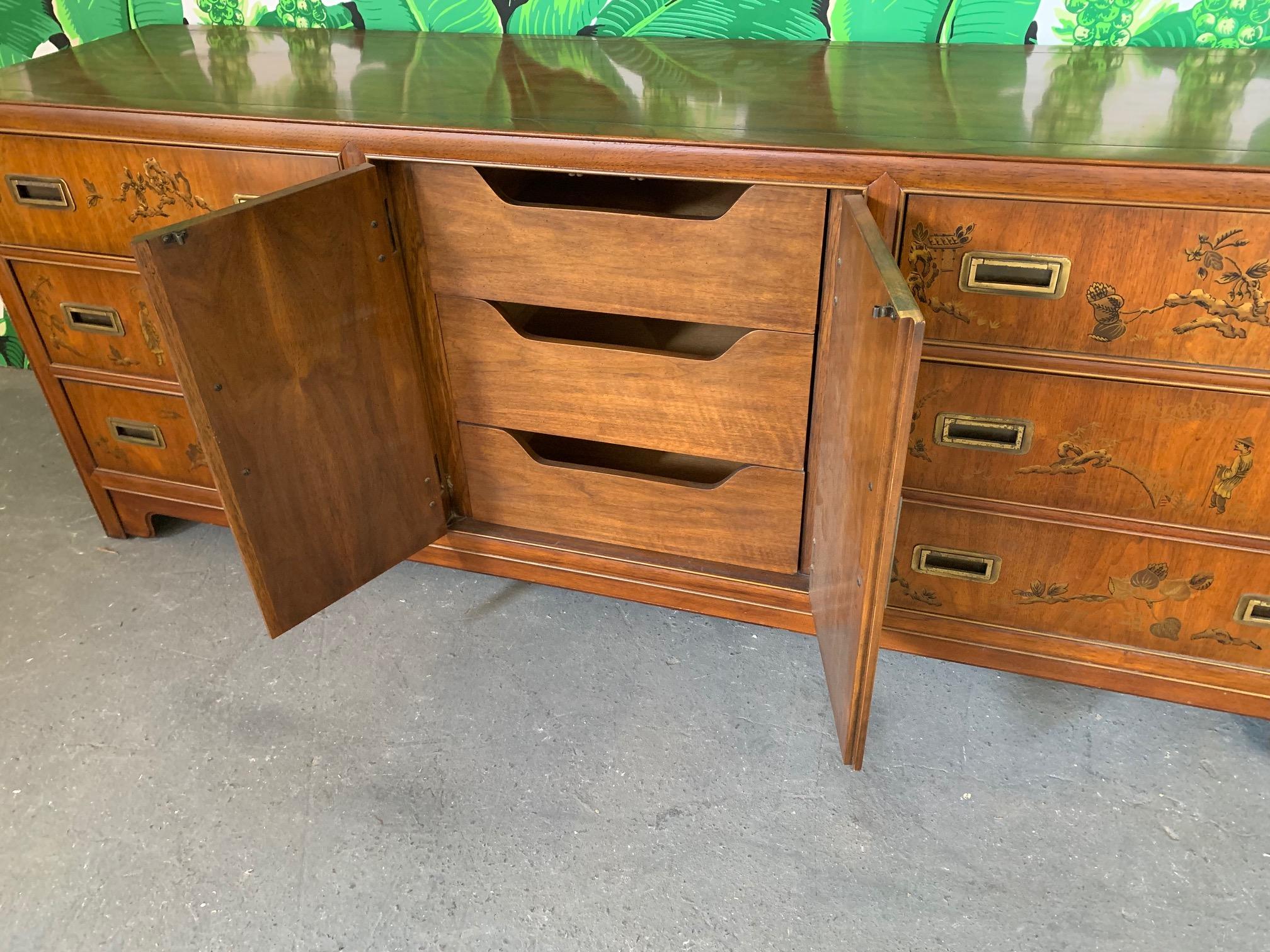 Vintage dresser from the Dynasty collection by Heritage Furniture features hand painted detailing and heavy brass hardware. Very good vintage condition with minor imperfections consistent with age.