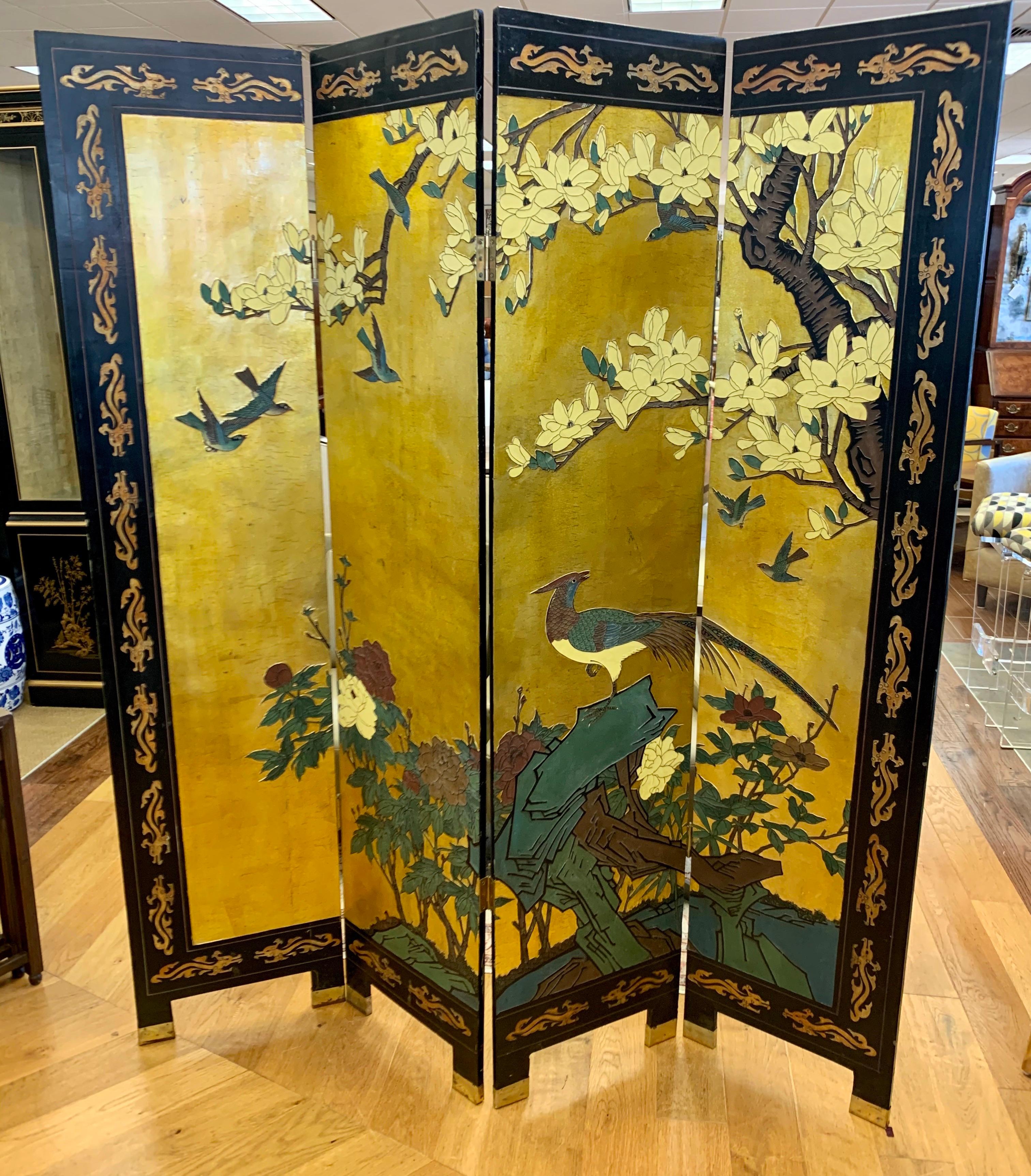 Exceptional detail throughout this vintage four-panel Asian chinoiserie folding screen/room divider. Front of screen features birds and flowers on a gold leaf background. Back of screen is black lacquer with green bamboo plants. Each panel measures