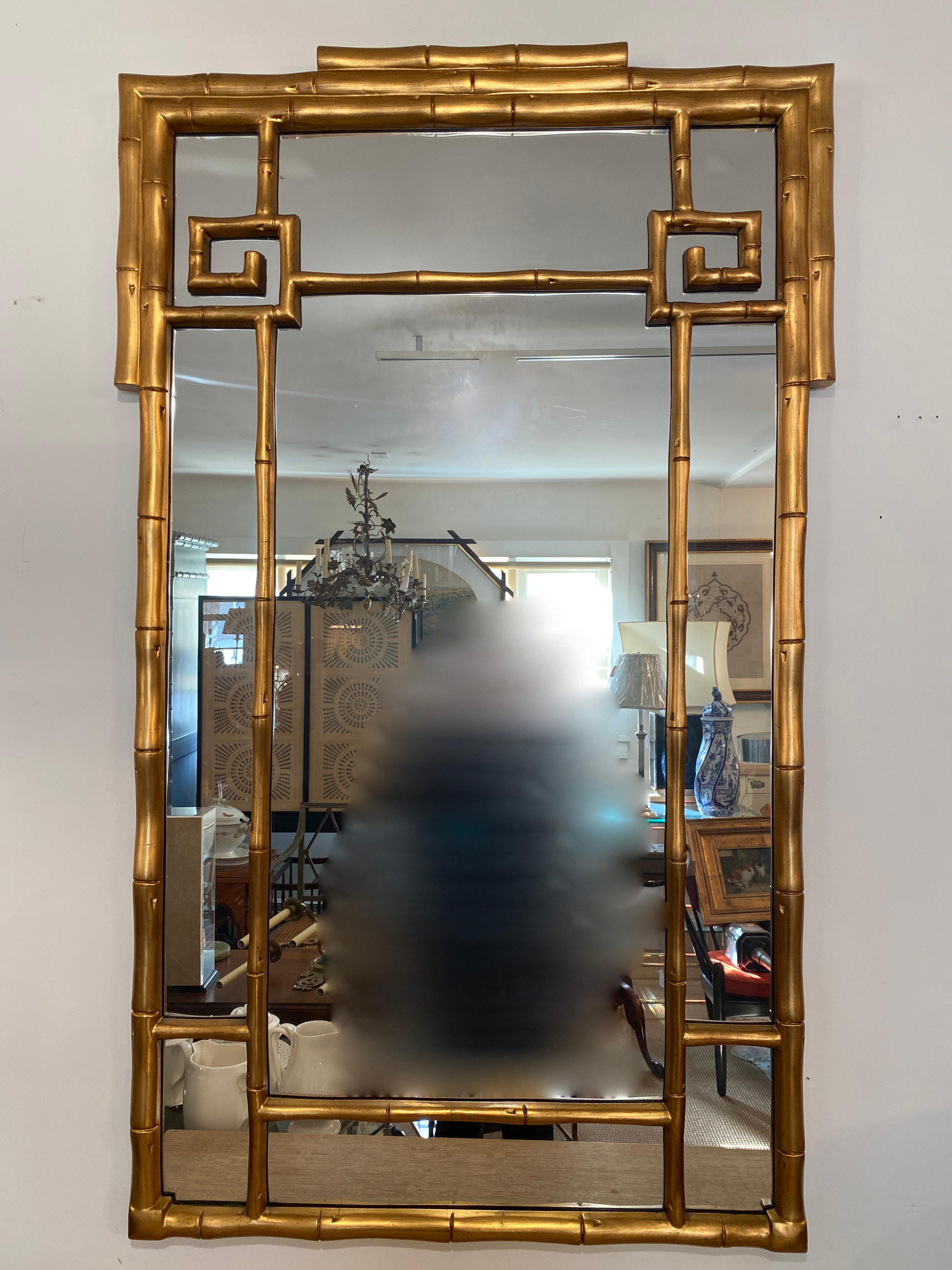This generously sized wall mirror, featuring a faux bamboo frame and chinoiserie influence, adds a subtle touch of Chinese aesthetic to your decor. In superb vintage condition