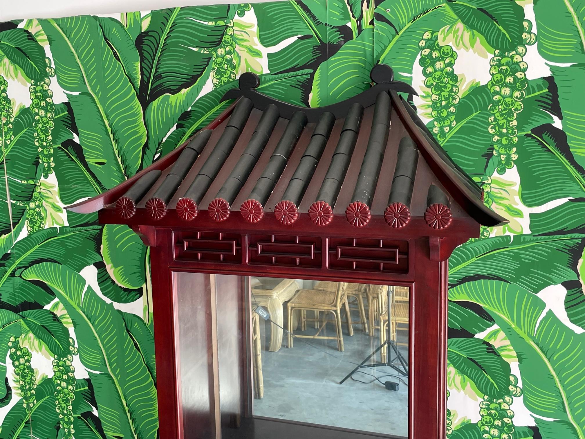 Asian style display cabinet features Chinese pagoda roof and fretwork stand. Interior access from locking side door. One drawer on each side of stand. Good condition with imperfections consistent with age. May exhibit scuffs, marks, or wear, see
