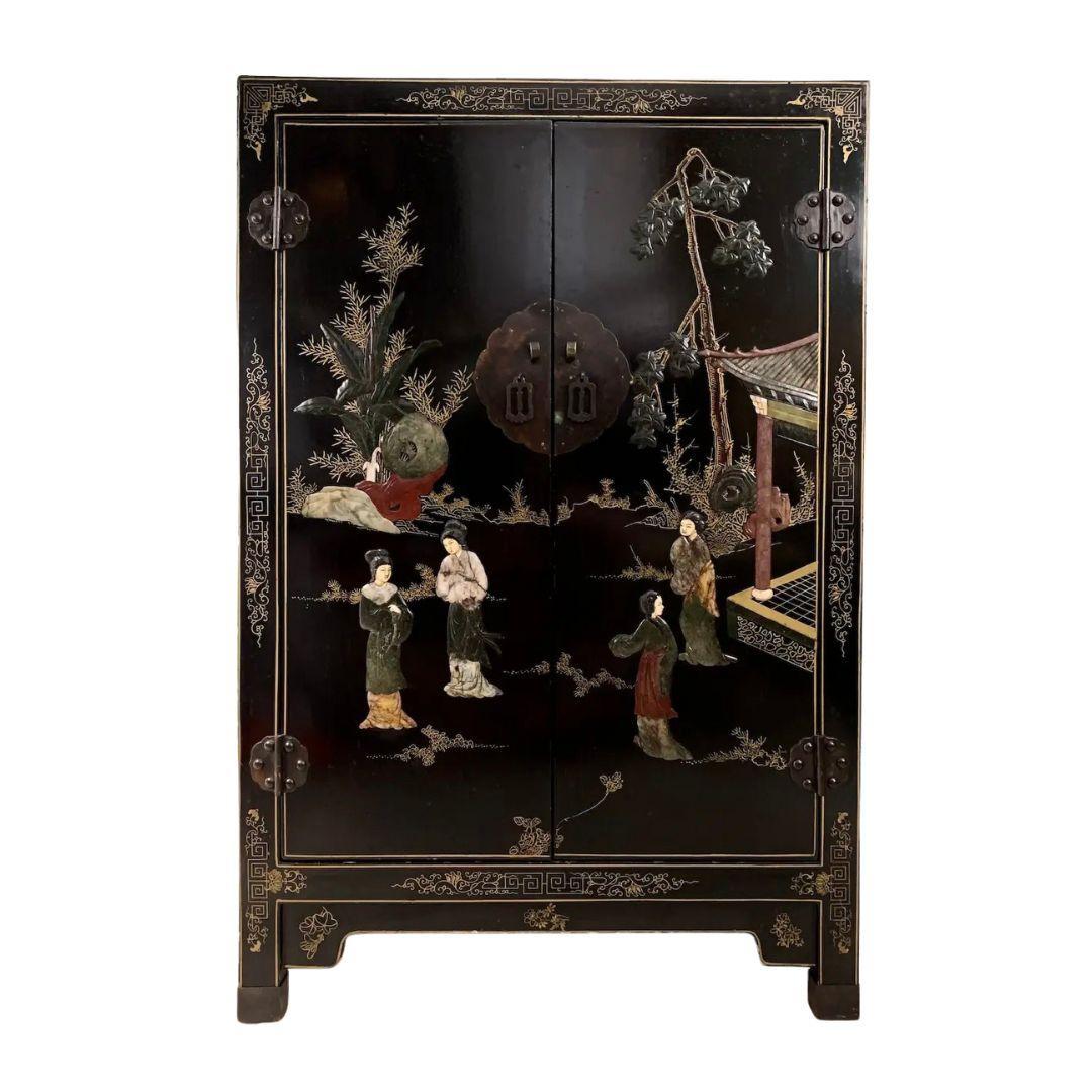 Early 20th century chinoiserie black lacquered cabinetry with semi-precious stone inlay. Constructed of solid elmwood with soapstone, jade, mother of pearl, and rose quartz appliqué. Exquisite artistry throughout displaying classic Asian inspired