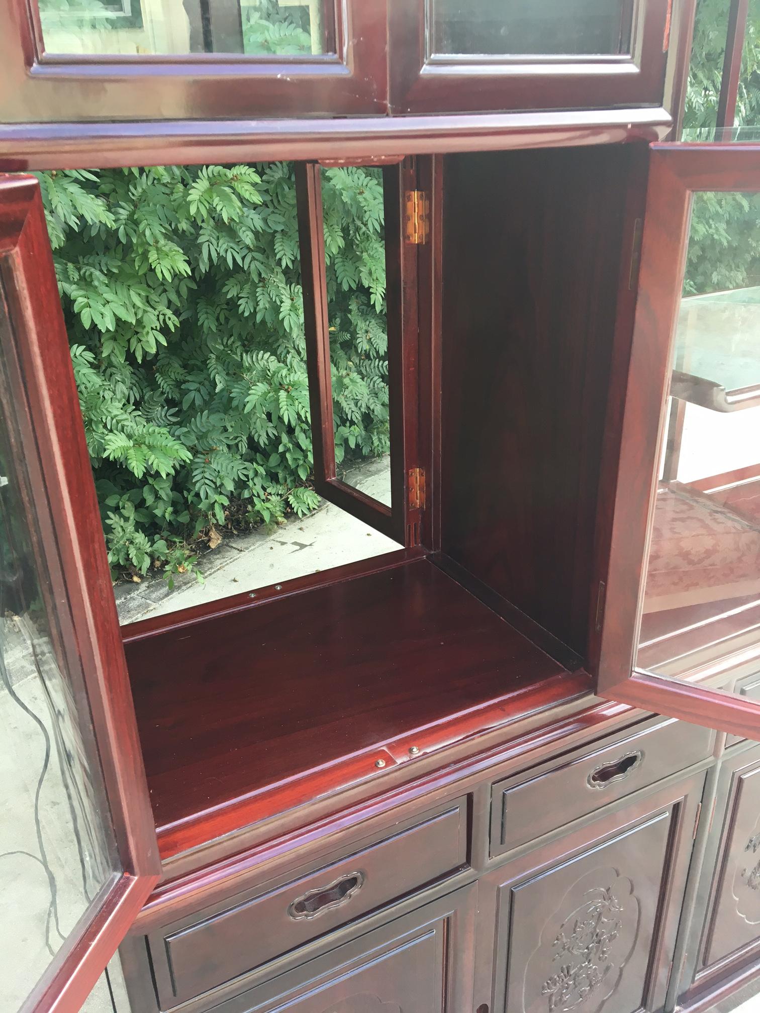 Unusual lighted Chinese chinoiserie hutch features a two-sided design. Drawers open from either side. Top and bottom cabinet doors reveal storage from either side. Three glass shelves in étagère section. Made from antique redwood. Brand emblem