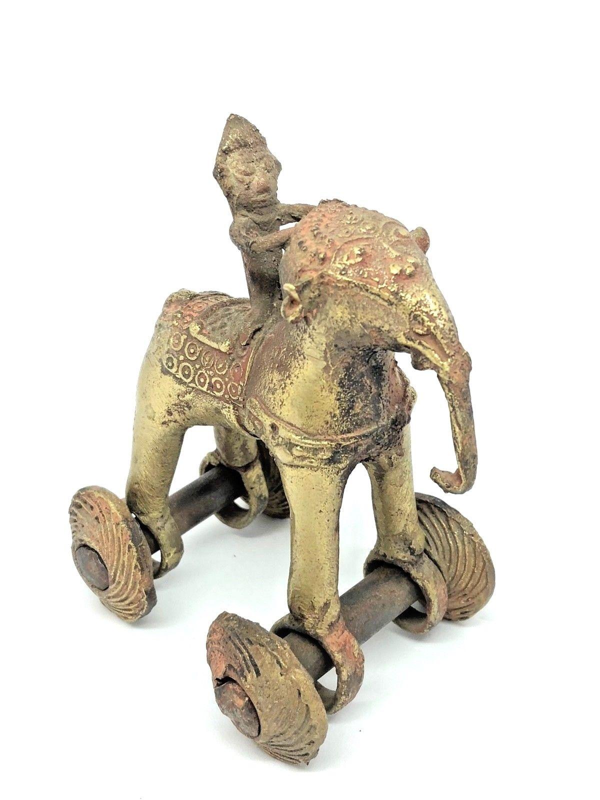 A decorative handmade elephant sculpture or toy on wheels. Some wear but this is old-age. Made of a brass or bronze. We think it is from Asia and was made early 20th century.