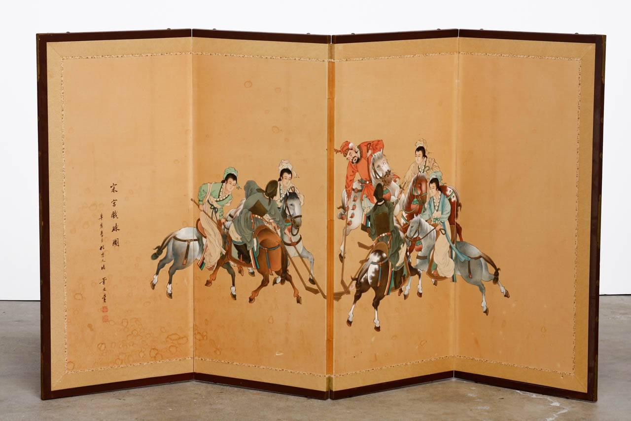 Colorful Asian four-panel Byobu style folding screen featuring a painted equestrian polo scene. Intricate artwork and detail on this unique screen probably from Republic period. Painted on paper with a silk brocade border and set in a wooden frame.