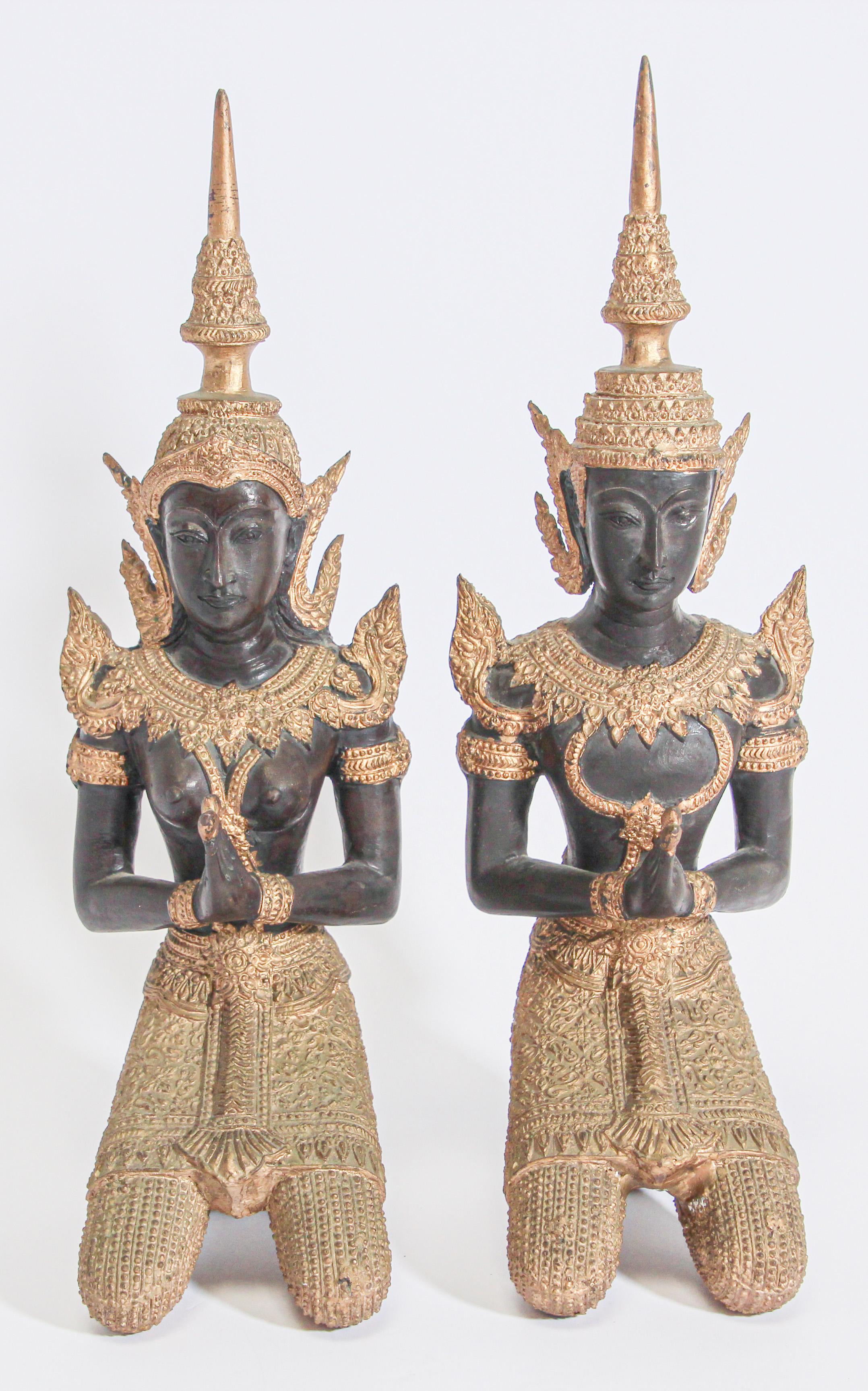 Gilt Kneeling Thai Buddhist gatekeeper male and female angels kneeling praying. 
Intricate Asian bronze Thai Teppanom kneeling Angels Buddha statues in black with the ceremonial costumes and the jewelry adorned with gold leaf details.
Teppanom are