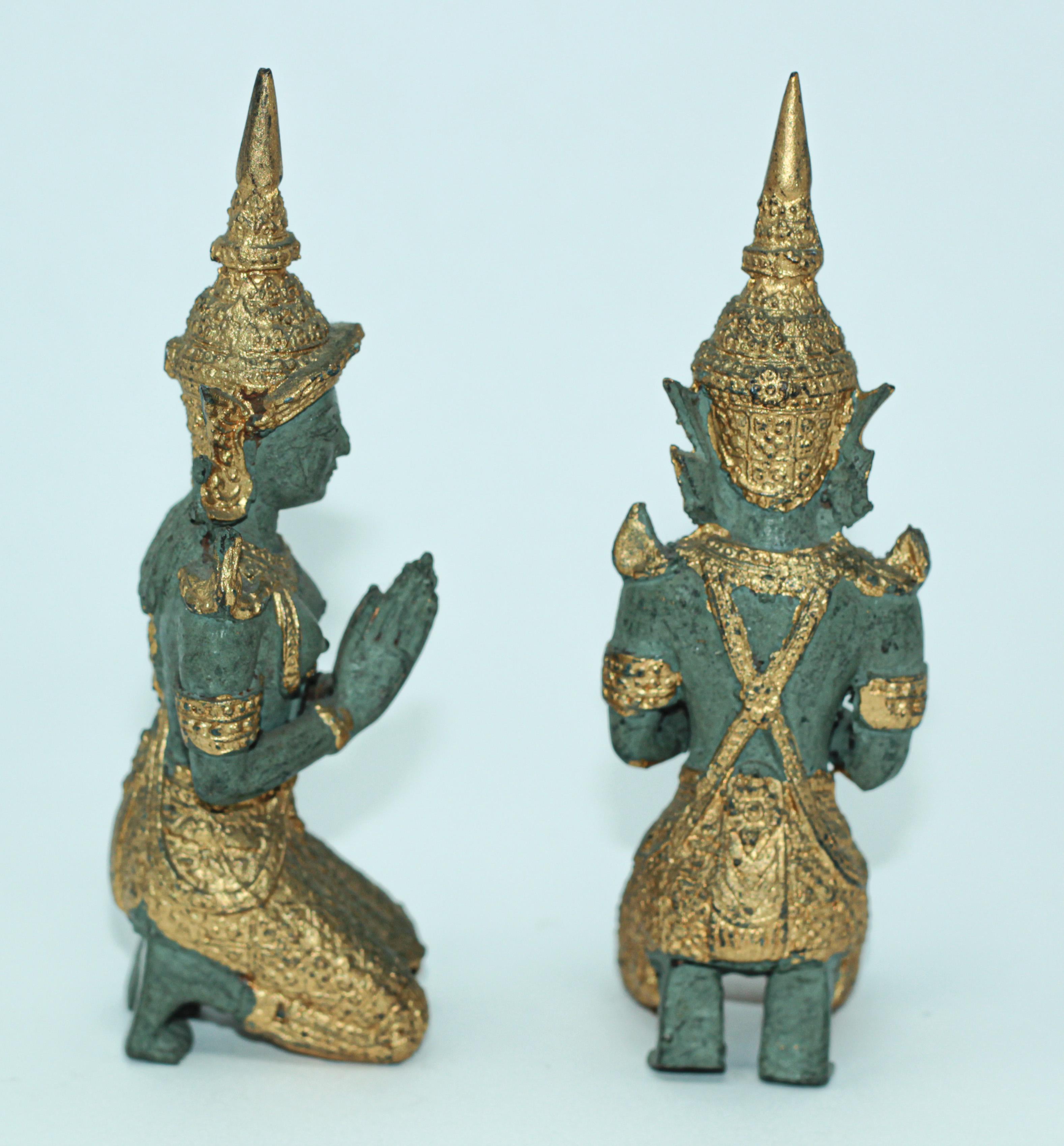 Small gilt Kneeling Thai Buddhist gatekeeper male and female angels kneeling praying.
Intricate Asian bronze Thai Teppanom kneeling Angels Buddha statues in black with the ceremonial costumes and the jewelry adorned with gold leaf
