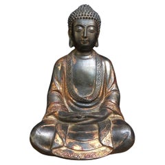Statua asiatica di Buddha seduto in bronzo dorato con gesto di entrambe le mani sulle gambe