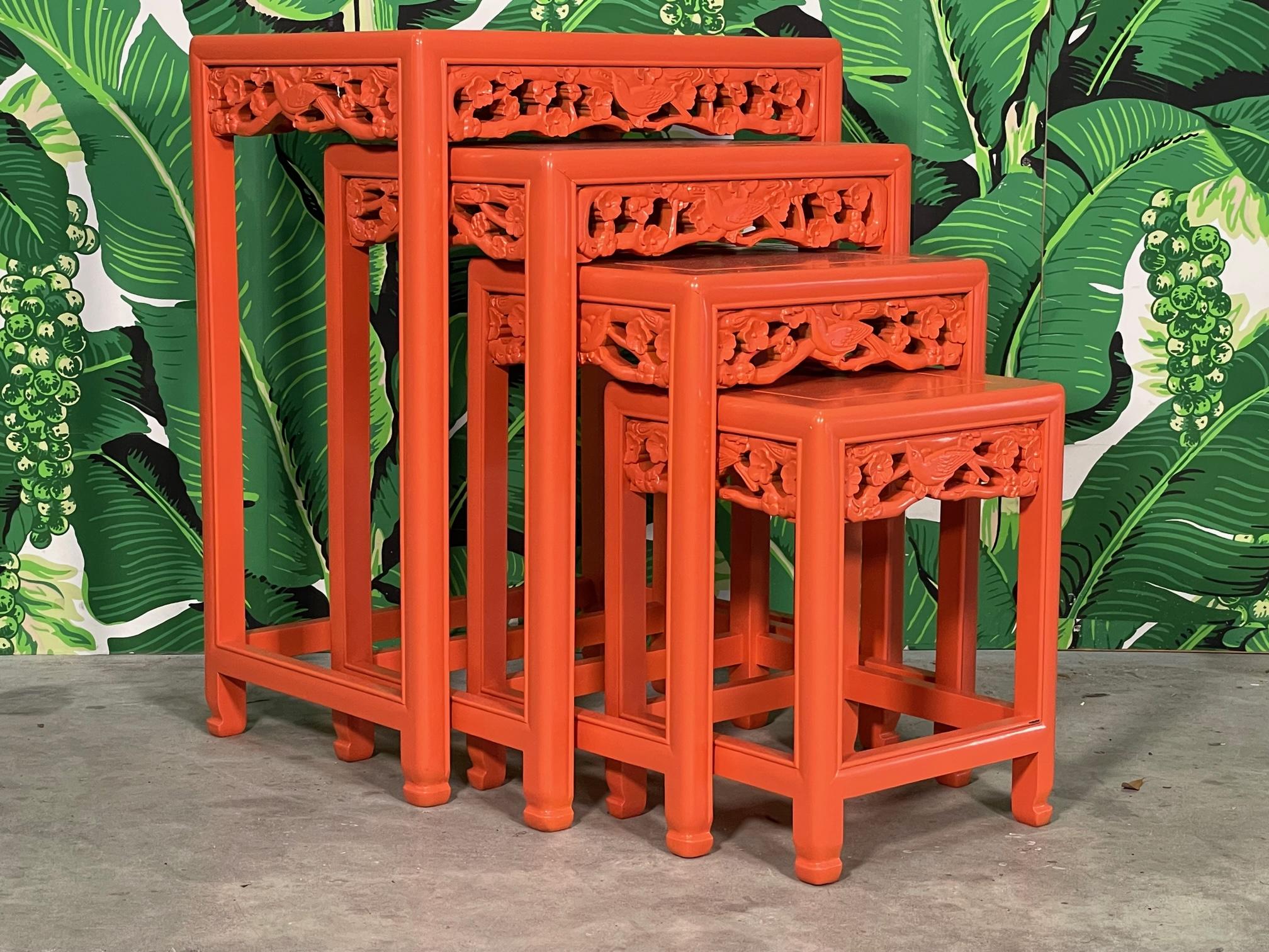 Set of four Asian carved wood nesting tables or stacking tables feature hand carved friezes with a bird and flower motif. Good condition with minor imperfections to the newly lacquered finish.
Size of each table:
Table 1: 19.75