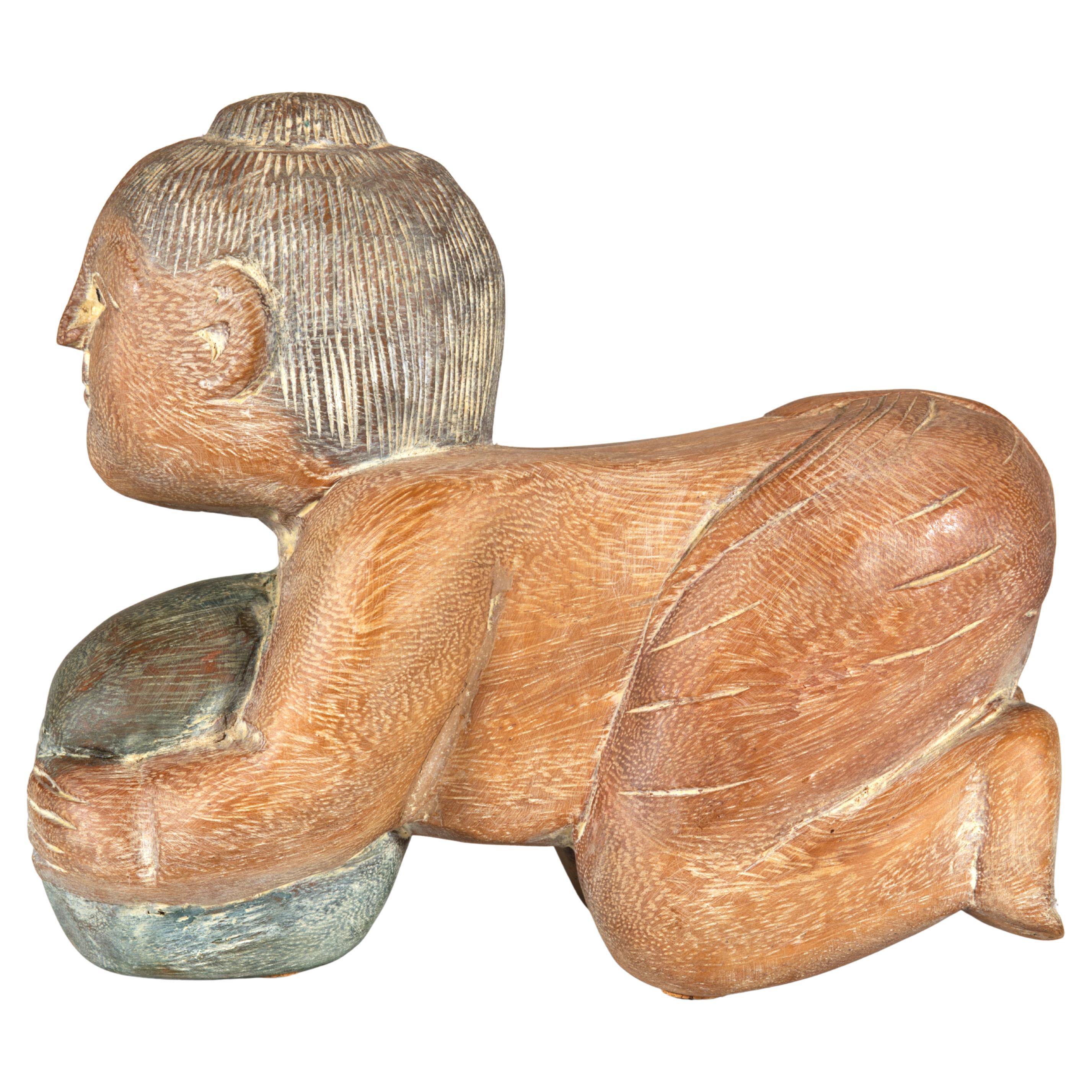 Buddha portafortuna asiatico in legno dipinto a mano su un melone