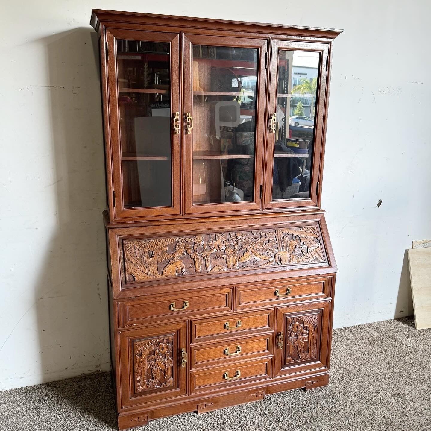 Enhance your home with the exquisite Asian Hand Carved Desk Cabinet, featuring intricate detailing and traditional motifs. The top section includes a display cabinet with glass doors, while the lower section functions as a secretary desk with ample