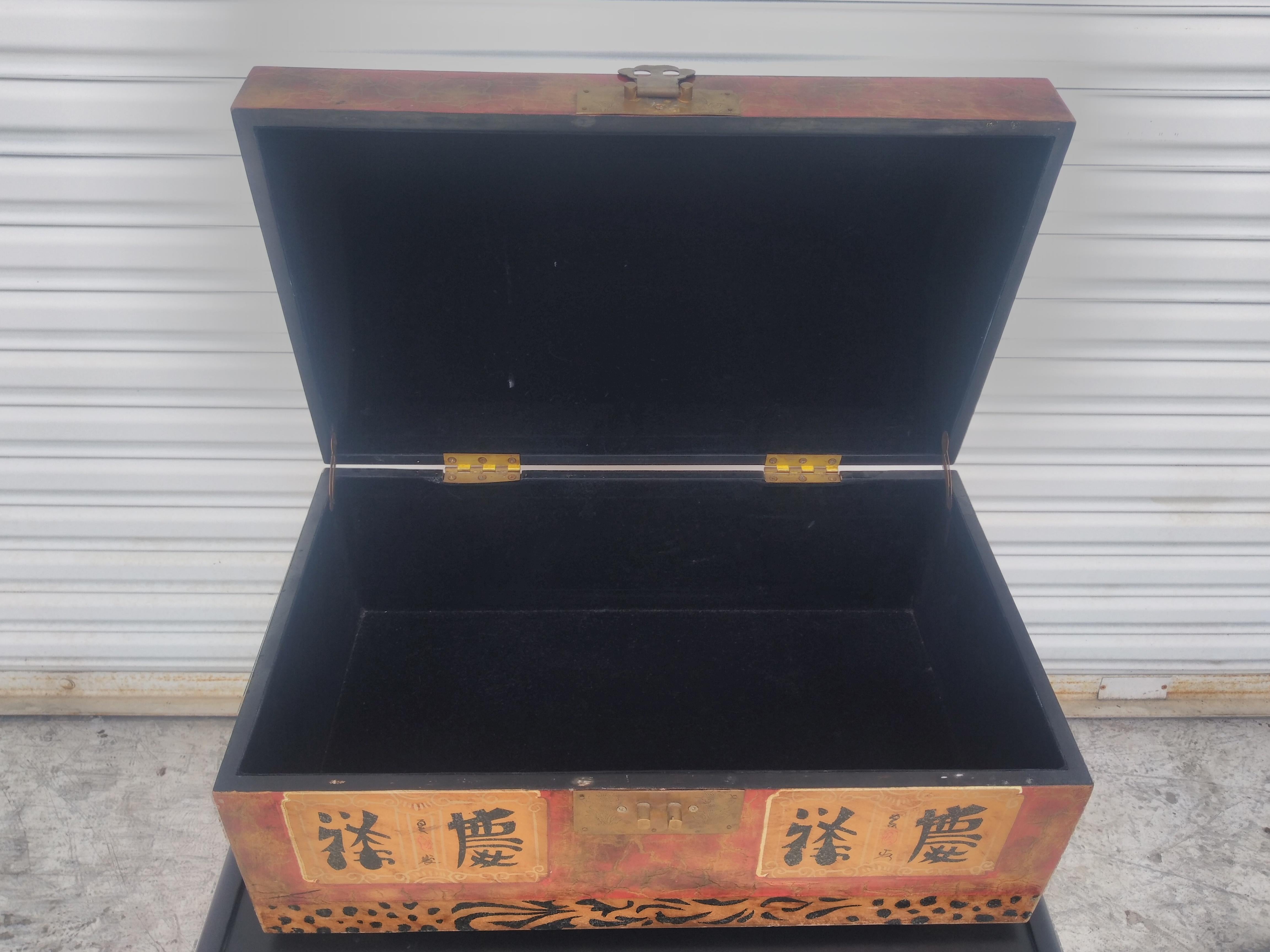 This is a handsomely decorated Chinese humpback chest. It's finely decorated with calligraphy. It has a very nice high gloss finish for added surface protection. 