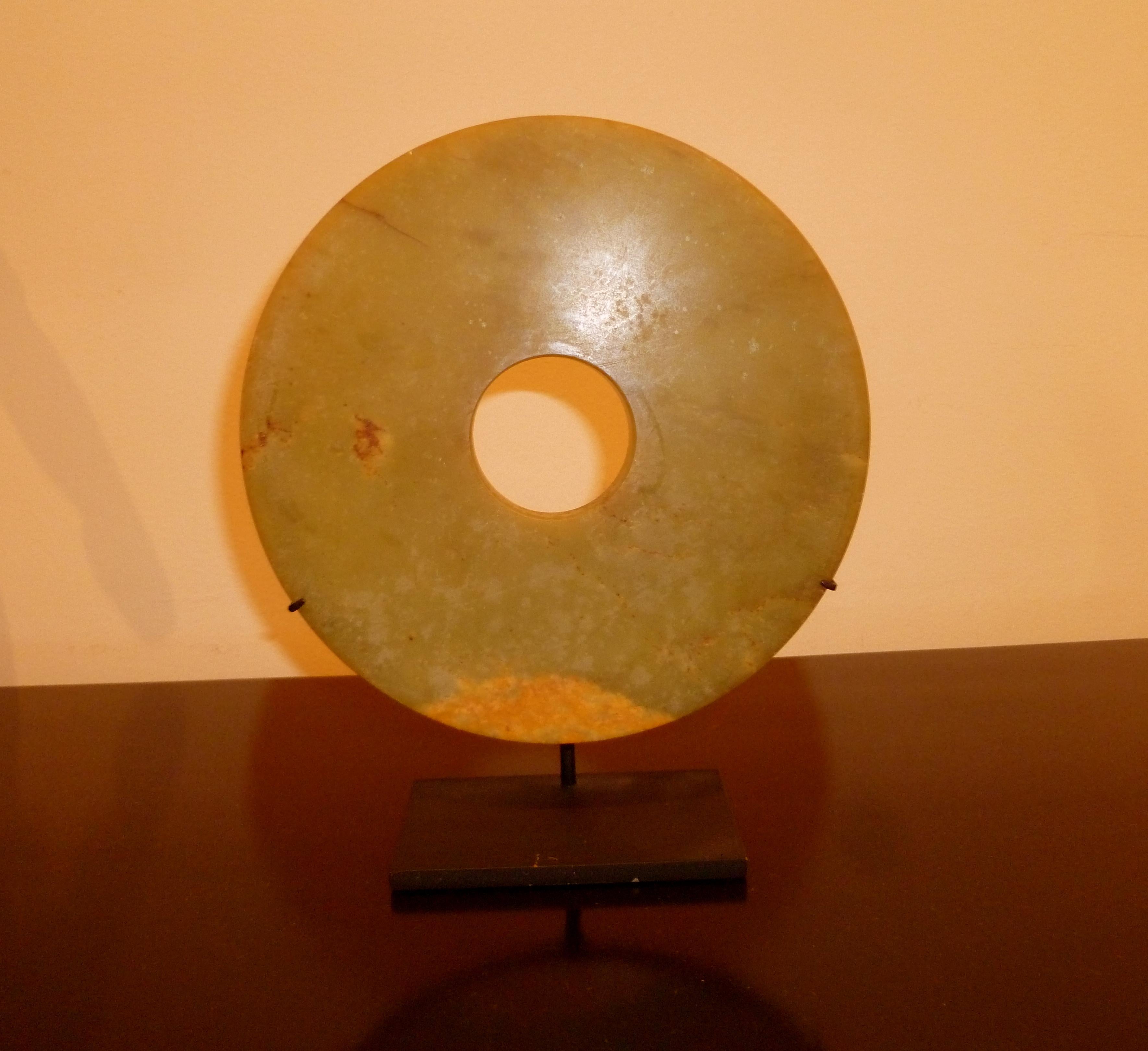 Fine Chinese hard stone disc on black metal stand, beautiful form, color and texture. Measures: 7
